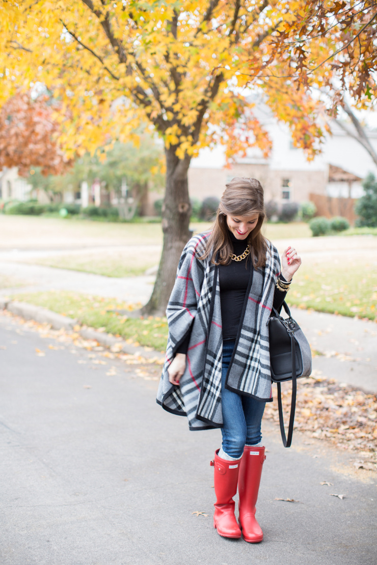 plaid cape and hunter boots