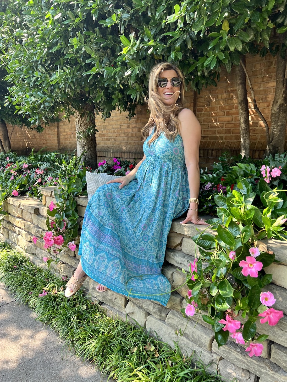 Brighton Butler wearing revolve blue floral dress with blue beach bag