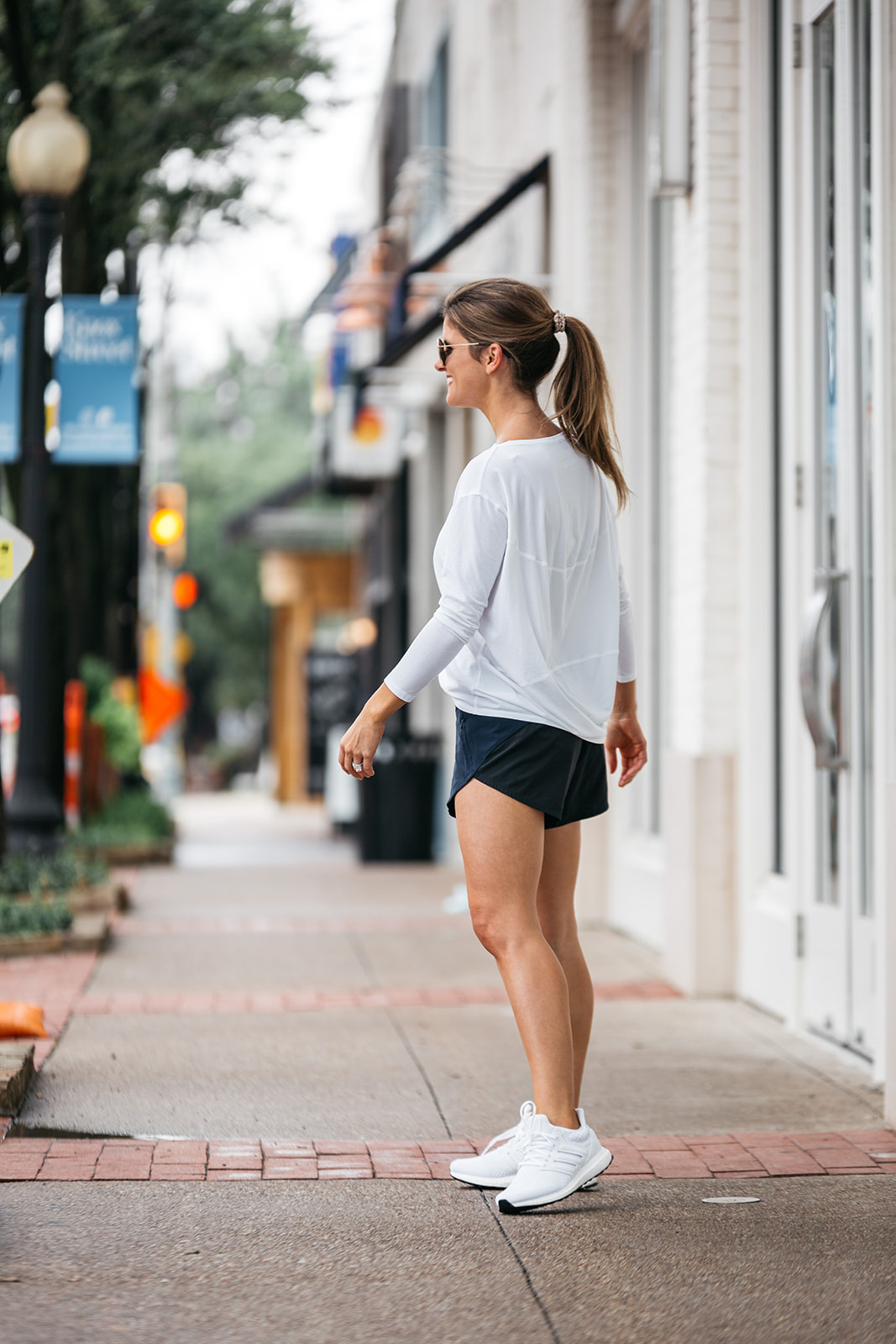 Brighton Butler wearing workout athelisure look, Lululemon all yours tee, outdoor voices shorts, Adidas ultraboost sneakers