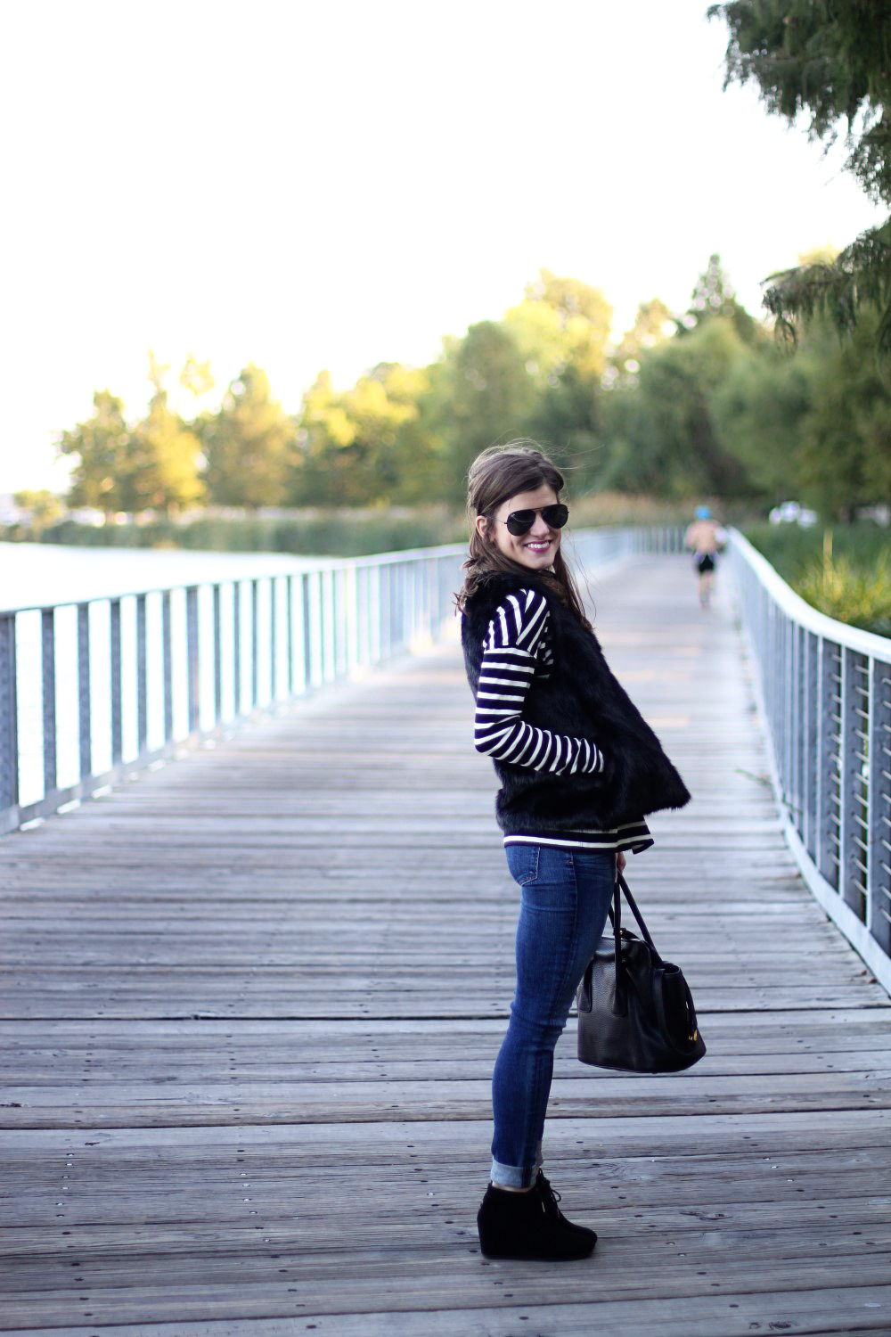 black faux fur vest and black and white striped turtleneck outfit