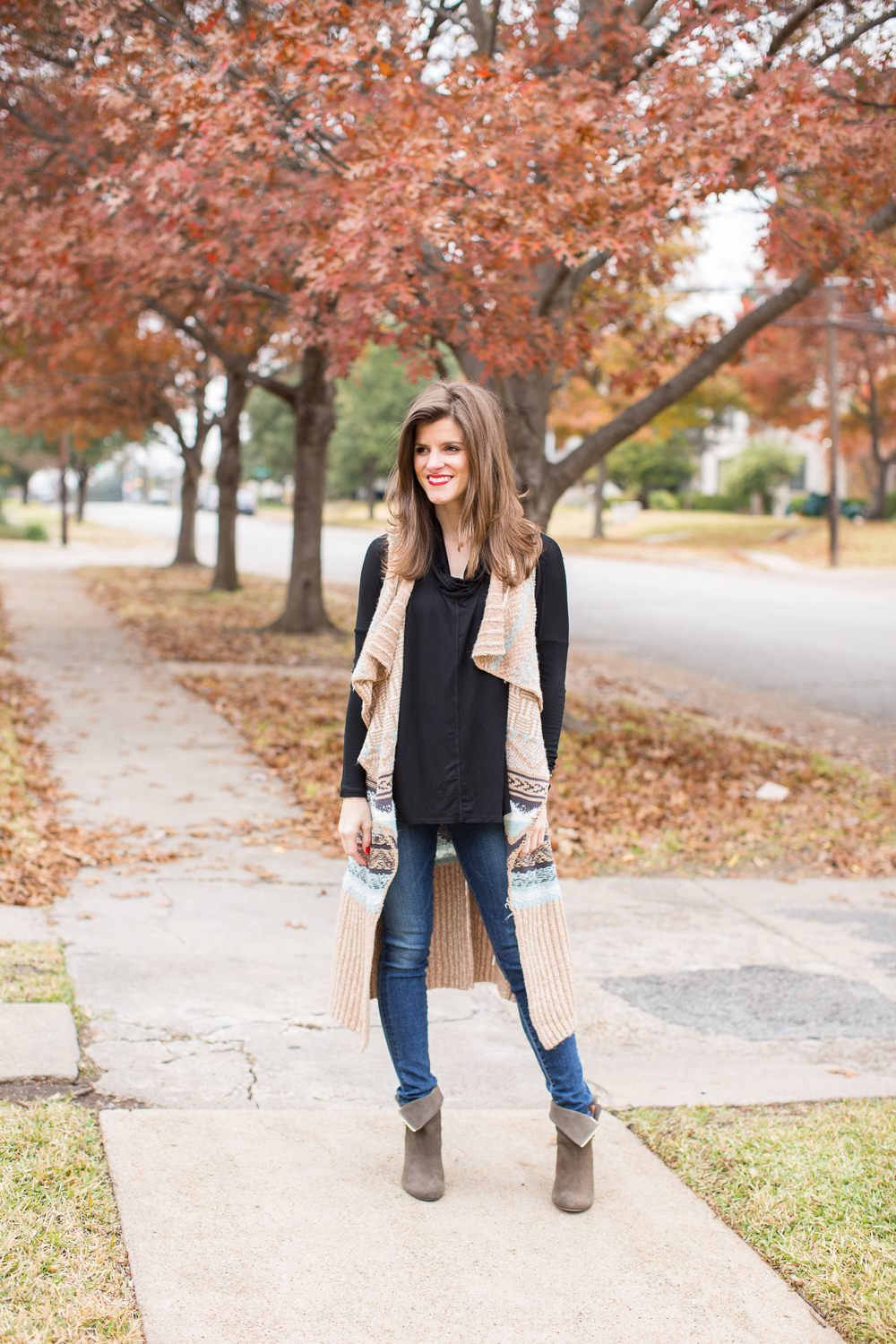 long vest outfit, black cowl neck tunic, jeans, booties