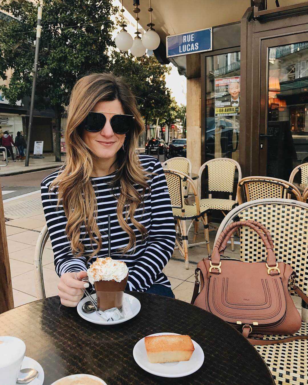 brighton keller drinking hot chocolate in vichy, france wearing striped top 