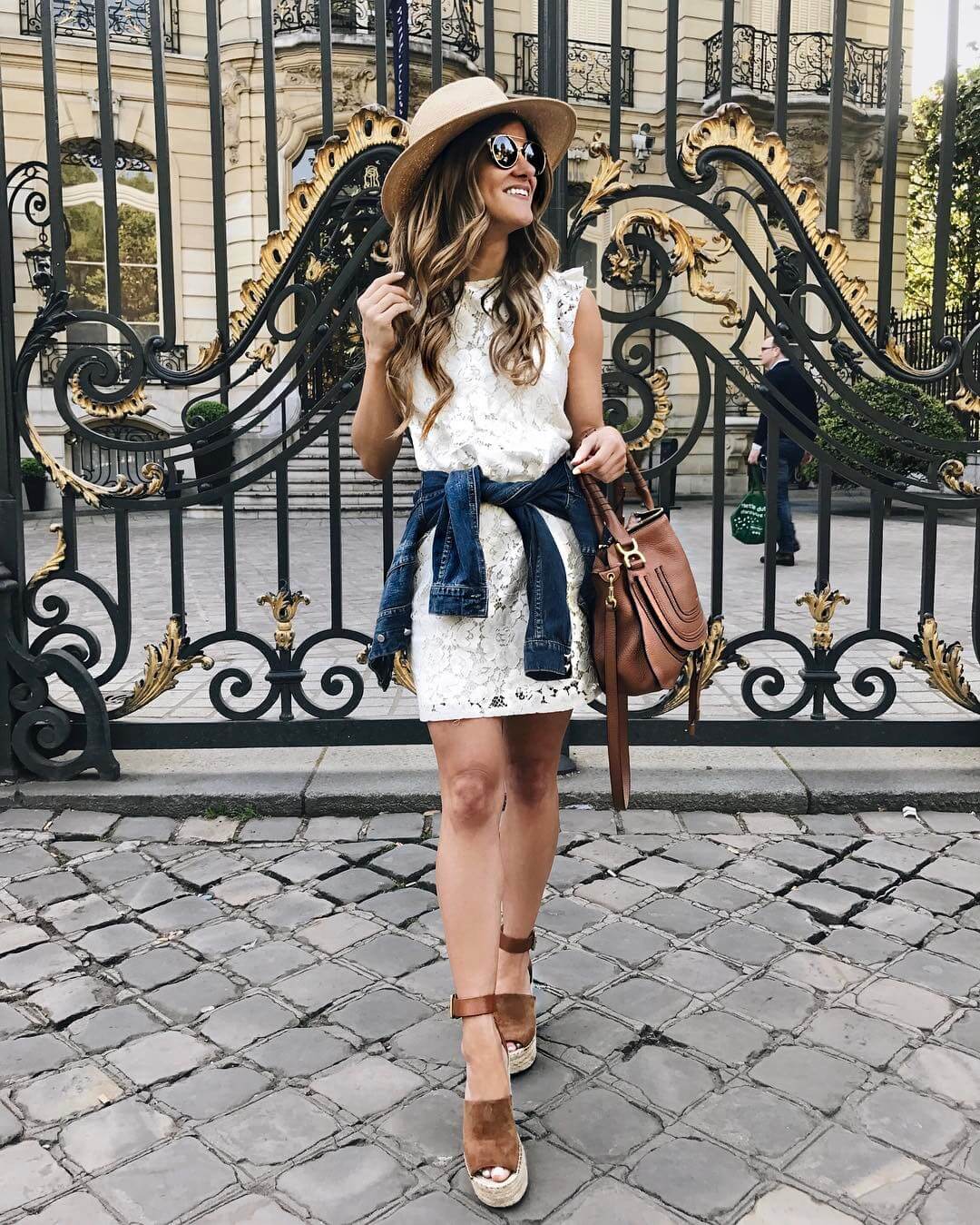 brighton keller ootd wearing white lace dress denim jacket and straw hat 