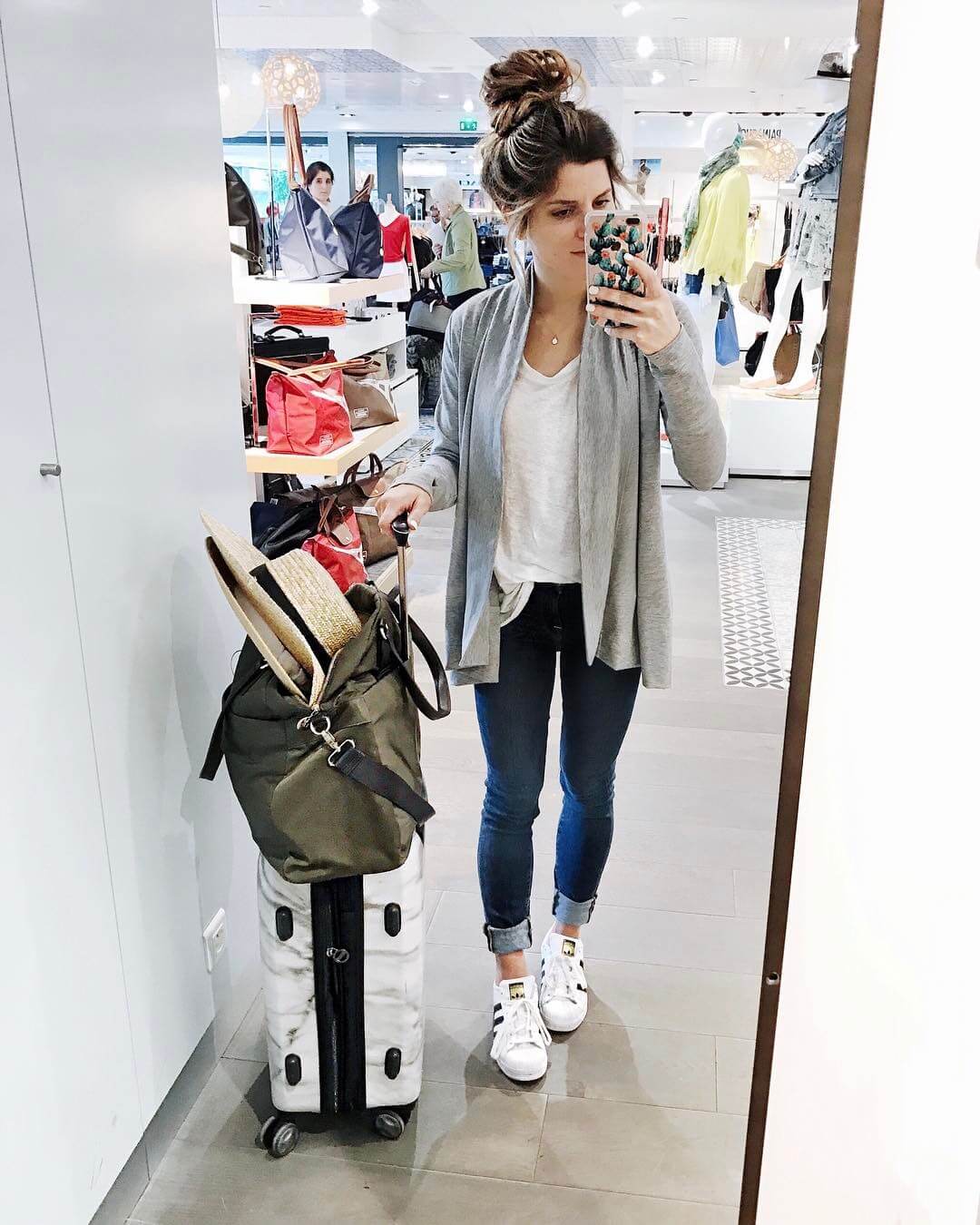 Brighton keller at Paris airport wearing travel outfit