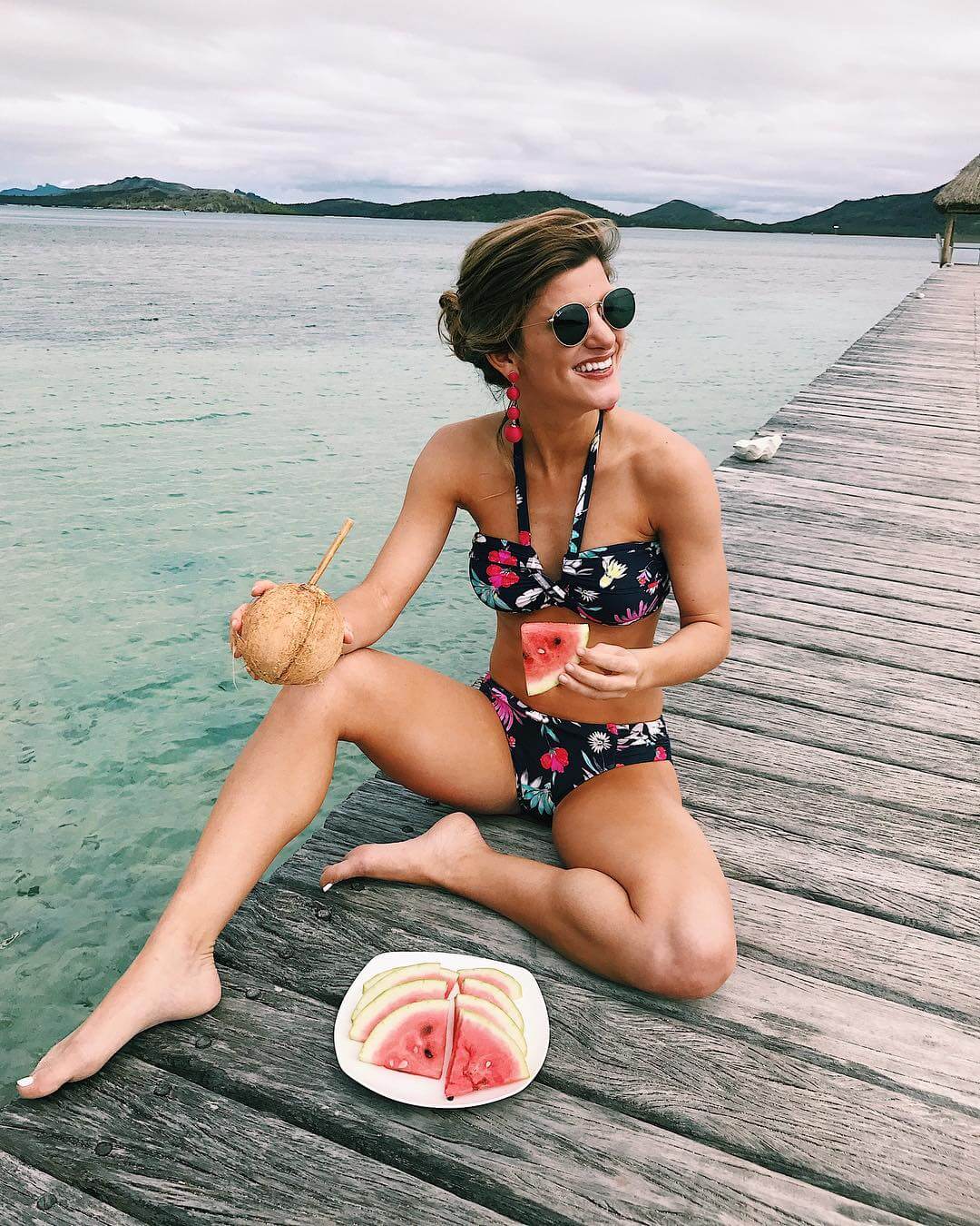 brighton keller sitting on dock wearing floral bikini