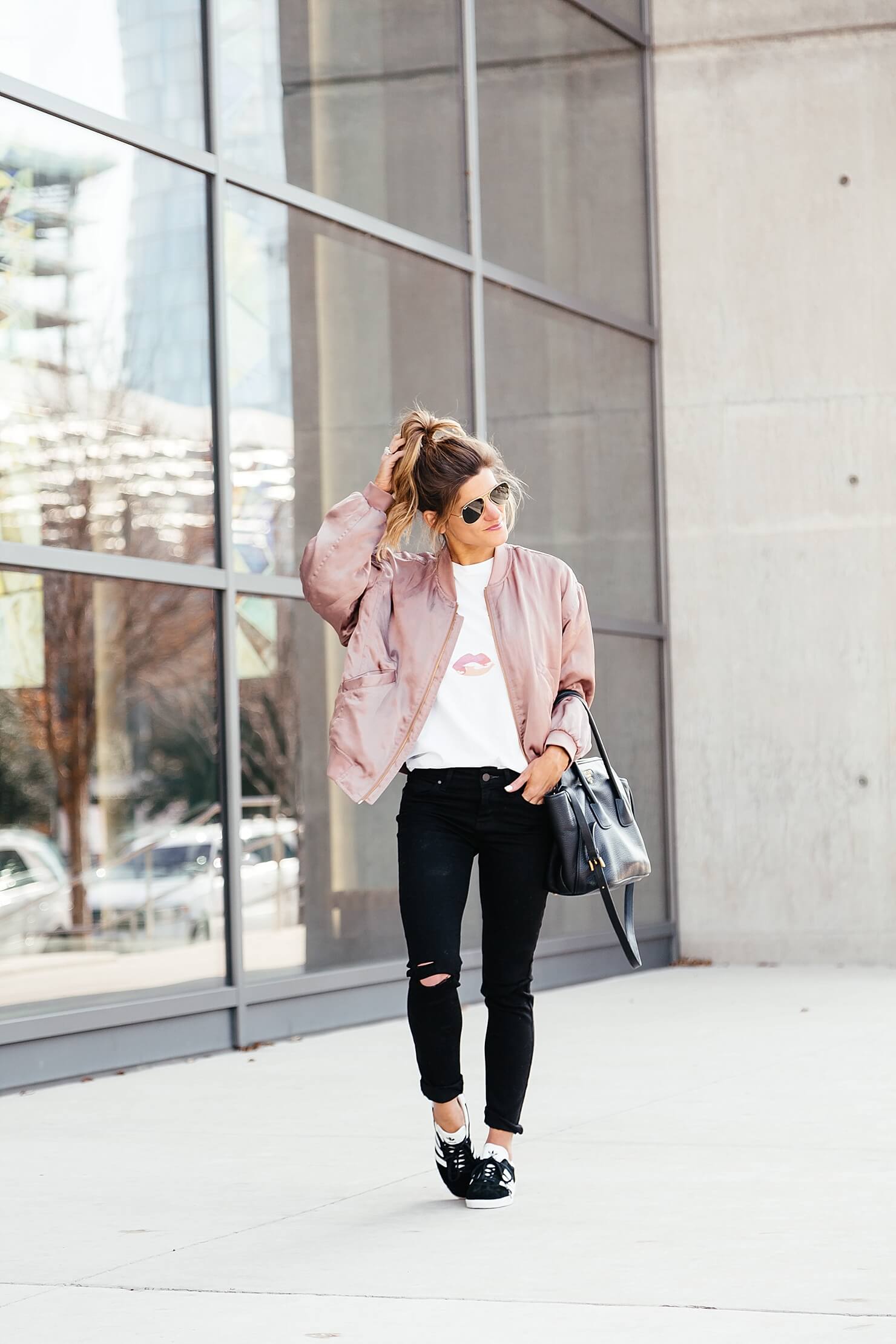 sincerely jules lips and lashes tee, leith pink bomber jacket, black jeans, casual everyday outfit, adidas gazelle sneakers