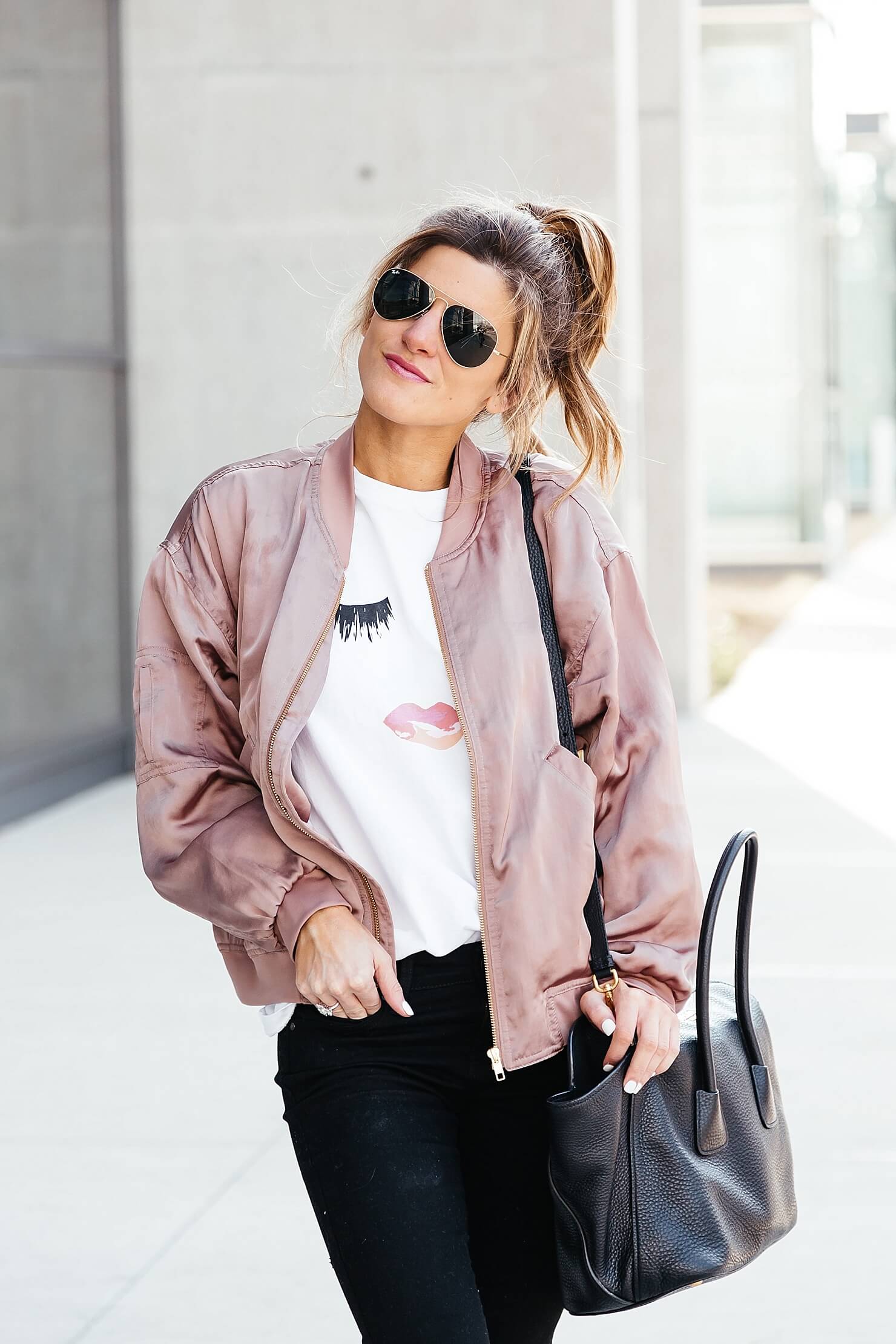 sincerely jules lips and lashes tee, leith pink bomber jacket, black jeans, casual everyday outfit, adidas gazelle sneakers