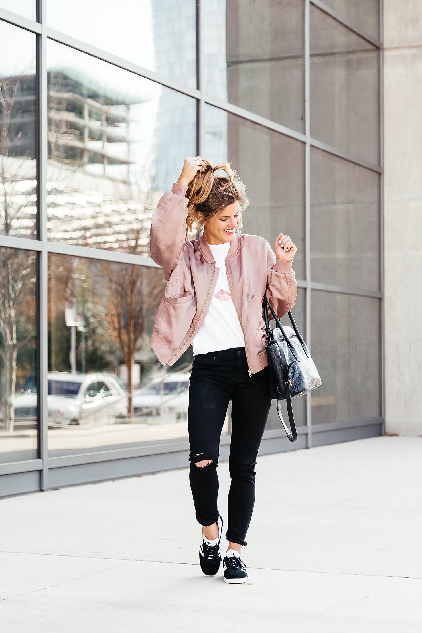 sincerely jules lips and lashes tee, leith pink bomber jacket, black jeans, casual everyday outfit, adidas gazelle sneakers