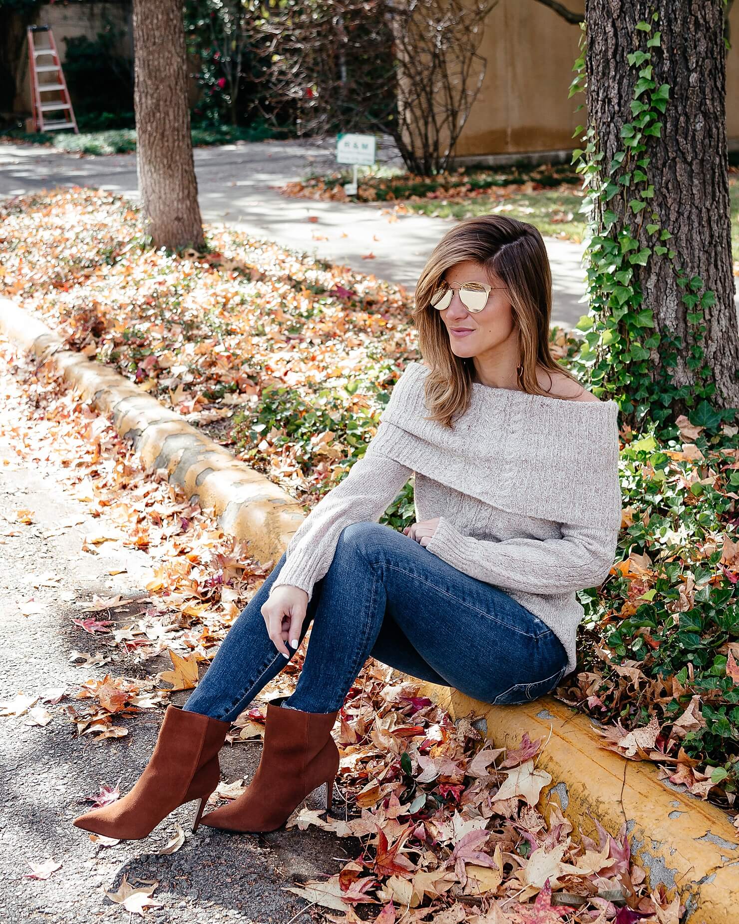 off the shoulder cable knit sweater, ag jeans, and brown heel booties