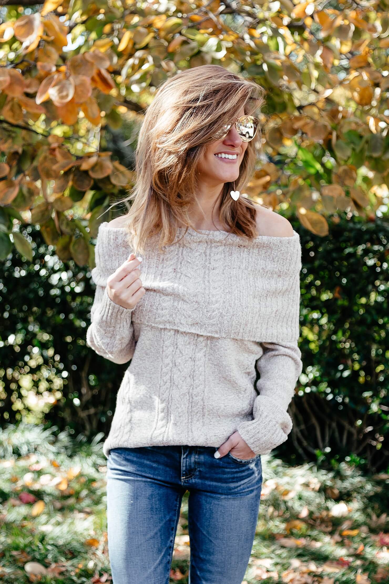 off the shoulder cable knit sweater, ag jeans, and brown heel booties