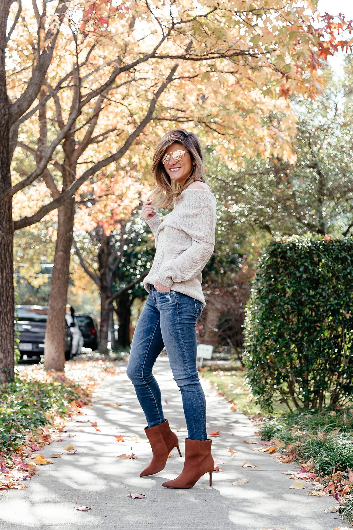 off the shoulder cable knit sweater, ag jeans, and brown heel booties