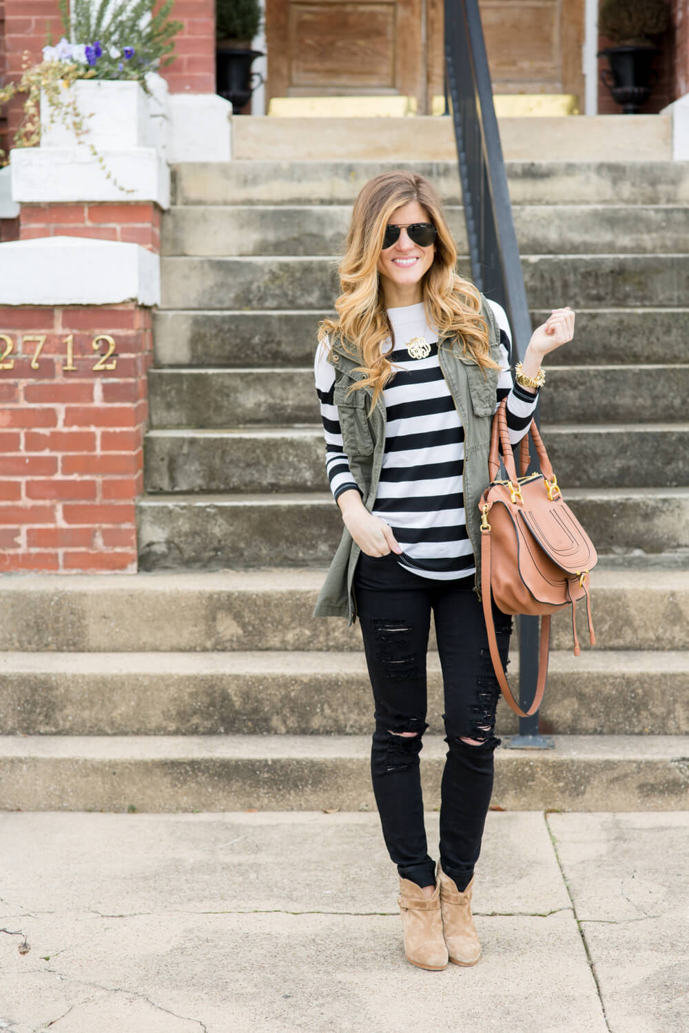 utility vest + black jeans + booties