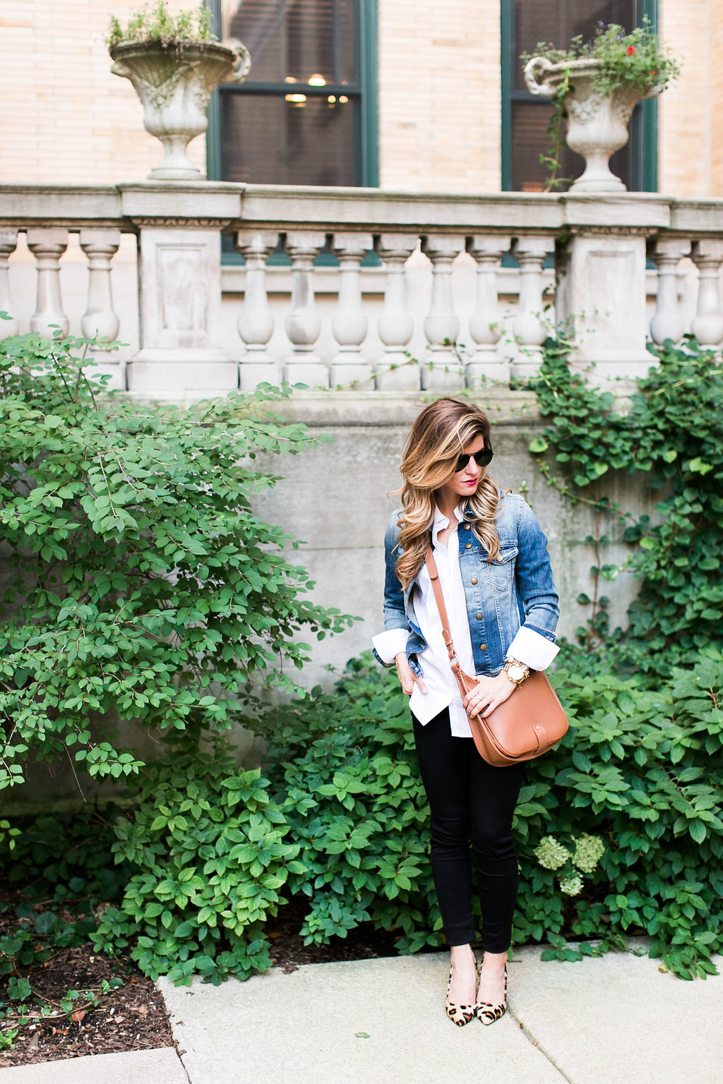 denim jacket and white button down and brown leather crossbody and leopard pointed toe heels