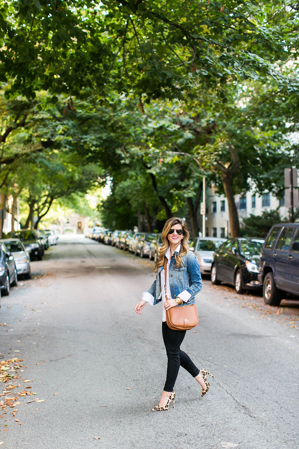 denim jacket and white button down and brown leather crossbody and leopard pointed toe heels