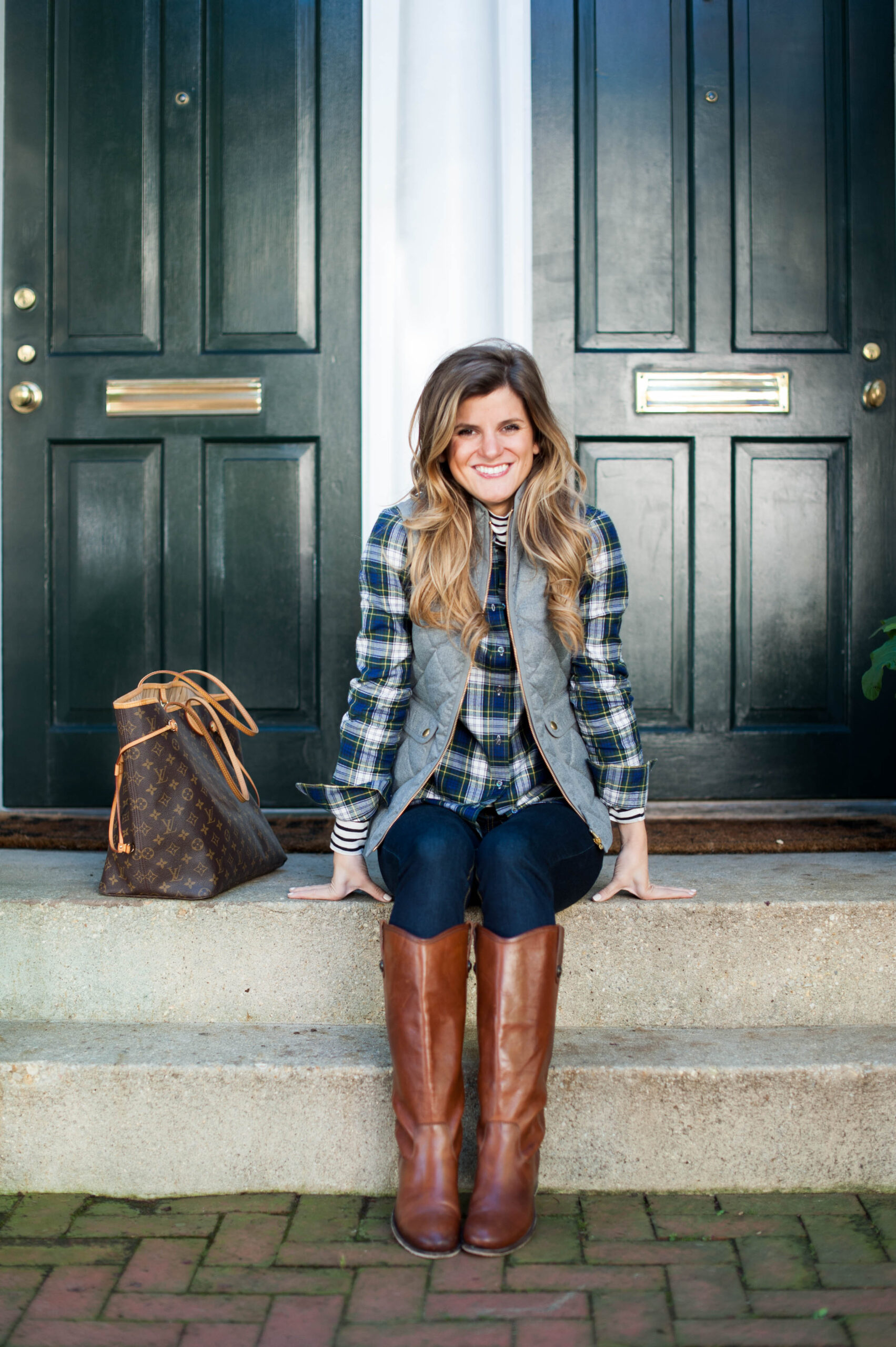 layered stripes and plaid under a puffer vest