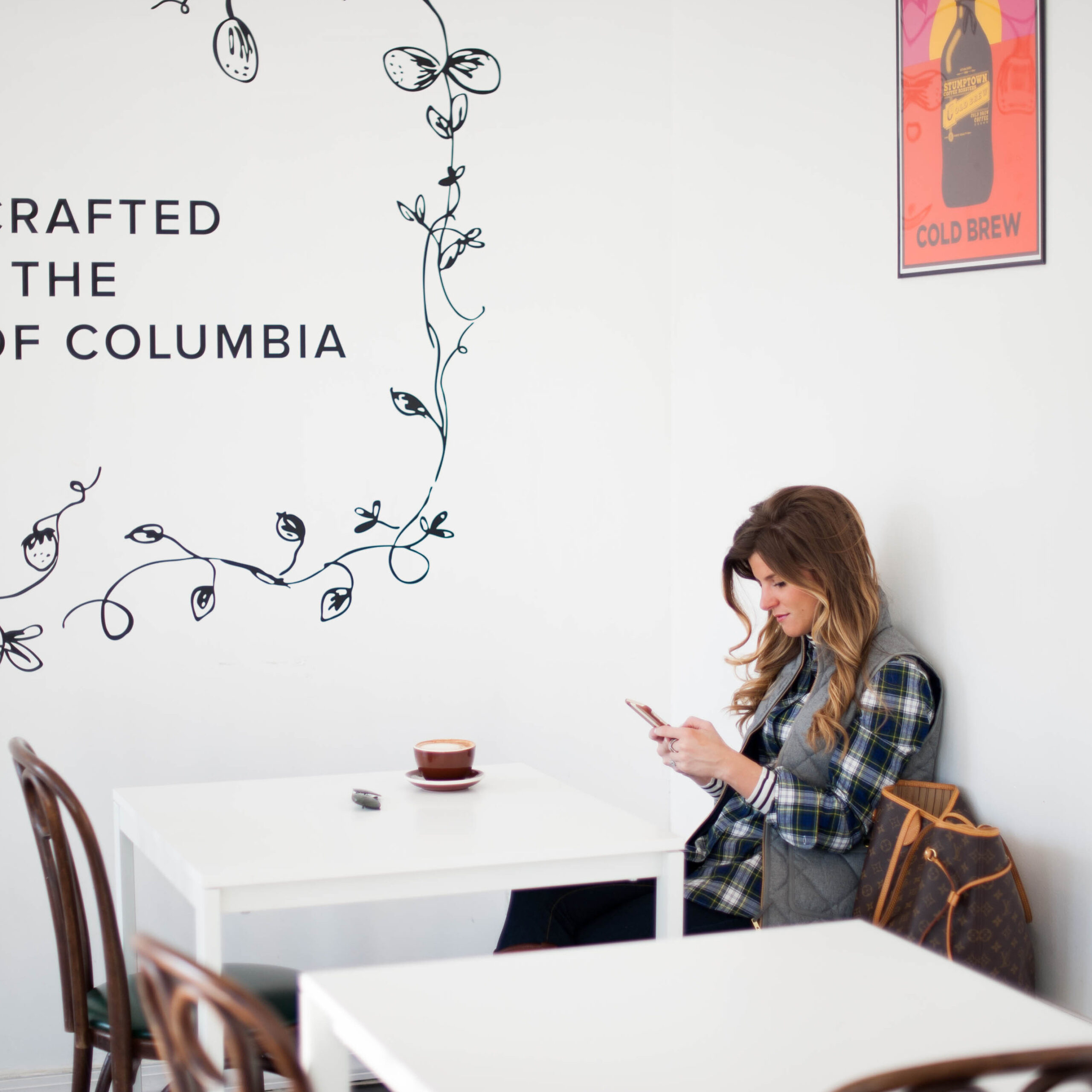 preppy outfit with striped turtleneck and plaid button up and grey puffer vest and pearls and coffee 