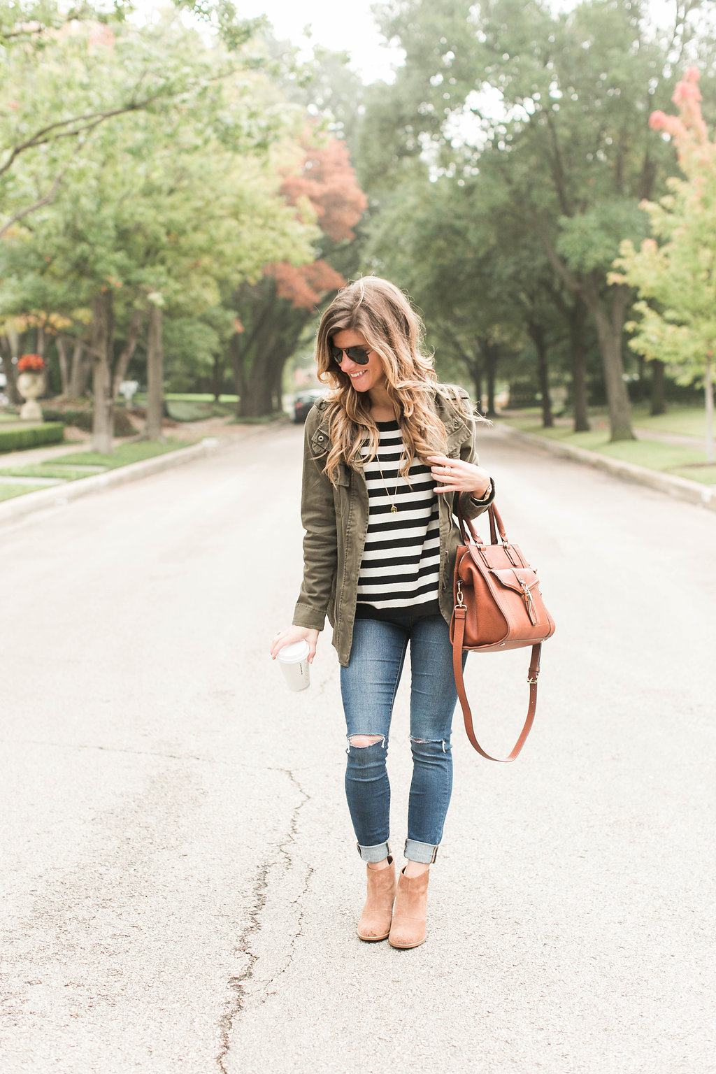 black and white stripes and utility jacket and coganc booties and brown bag