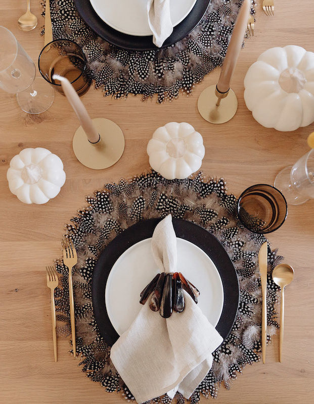 Brighton Butler Fall Tablescape with black and white plates and feather placemat