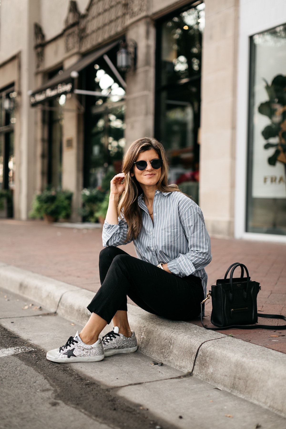 Brighton Butler wearing Abercombie striped shirt, black jeans and golden goose sneakers silver glitter with black star and black laces