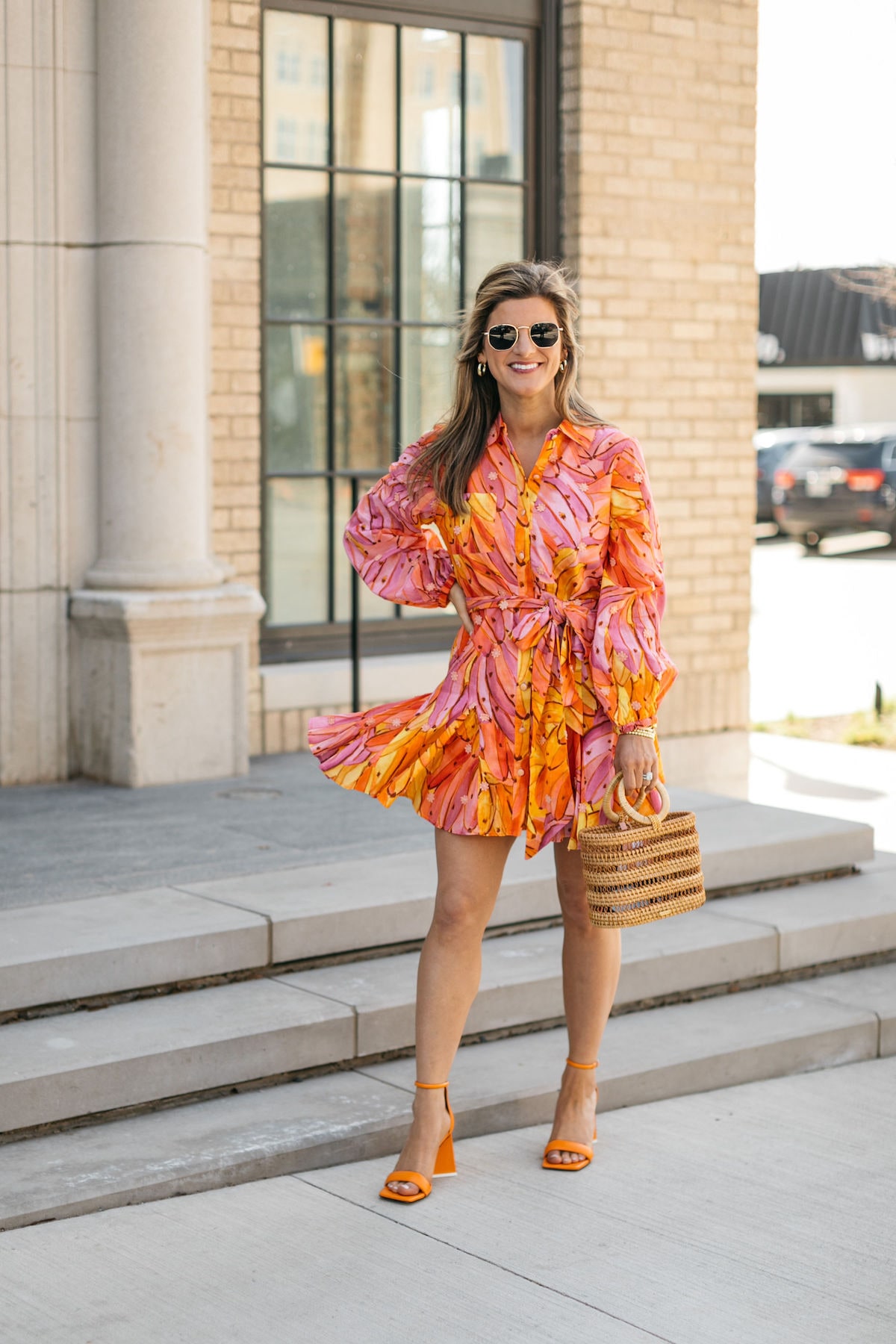 Brighton Butler wearing Farm rio banana dress with cult gaia bag and orange sandals