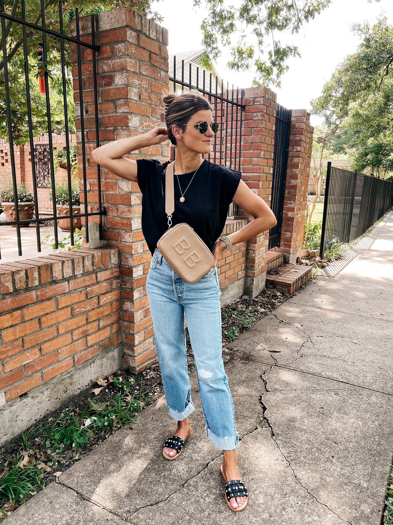 Brighton Butler wearing black tee and light wash jeans