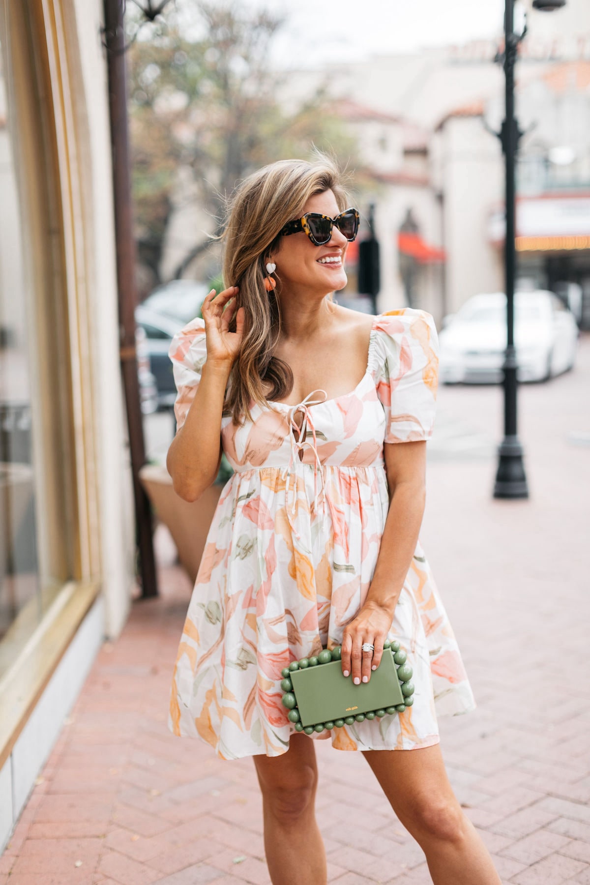 Brighton Butler wearing abercrombie mini dress with coral heels and cult gaia bag