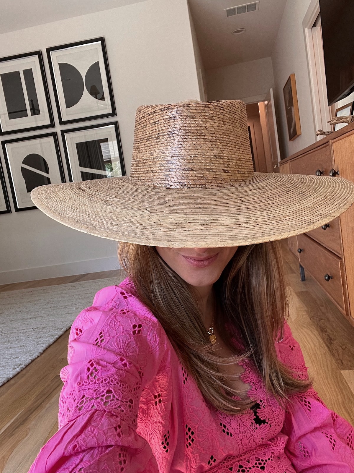 Brighton Butler wearing pink dress and boater hat