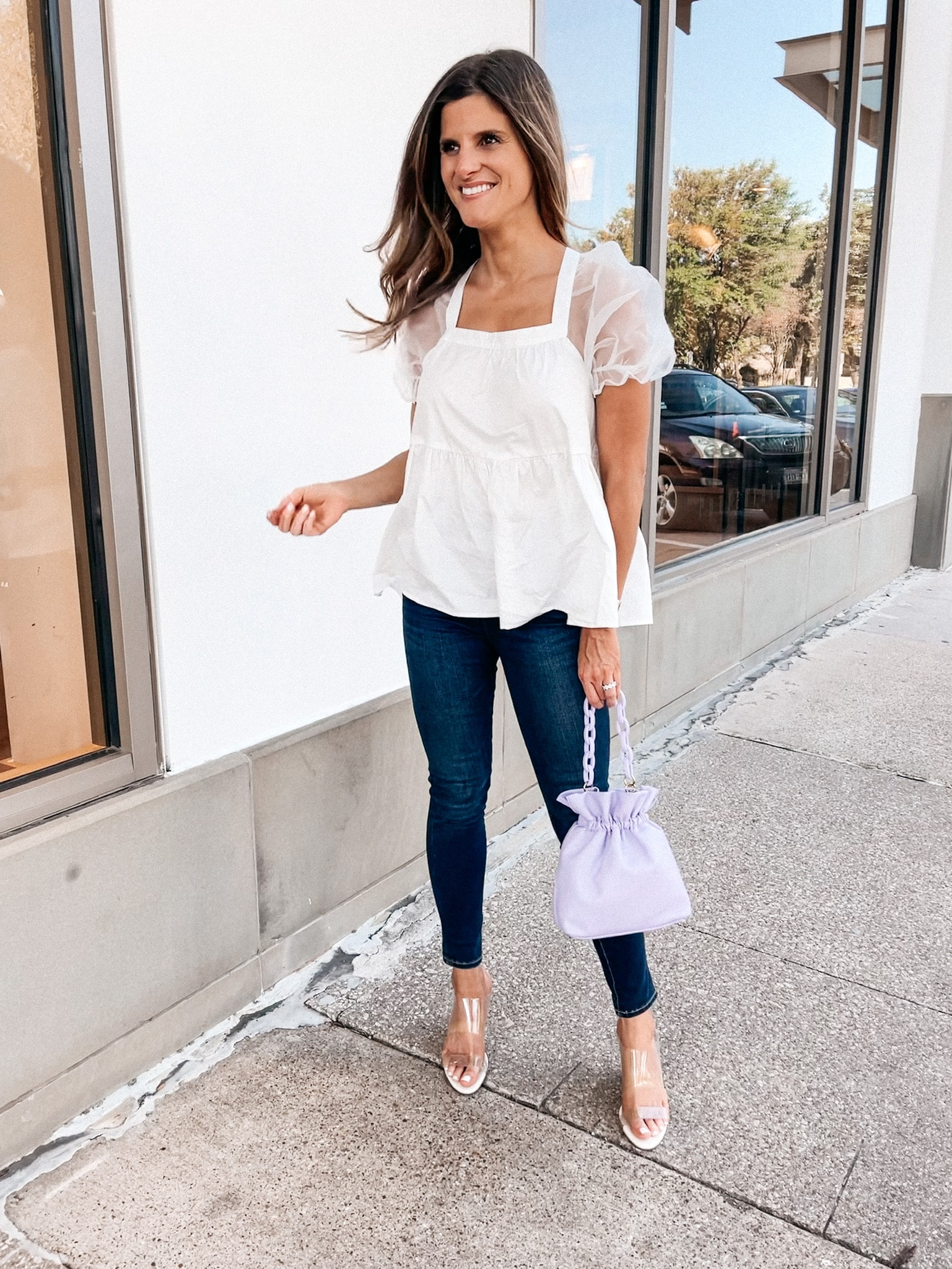 Brighton Butler wearing white puff sleeve top from tuckernuck and jeans