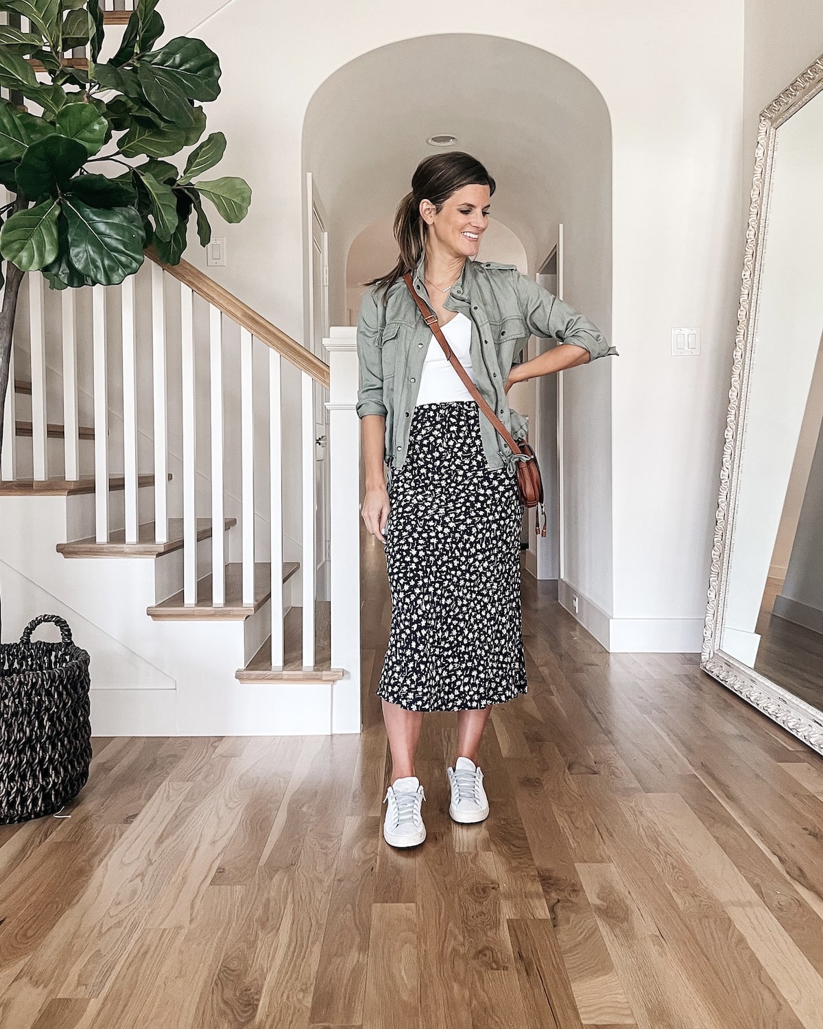 brighton butler wearing white body suit with midi skirt