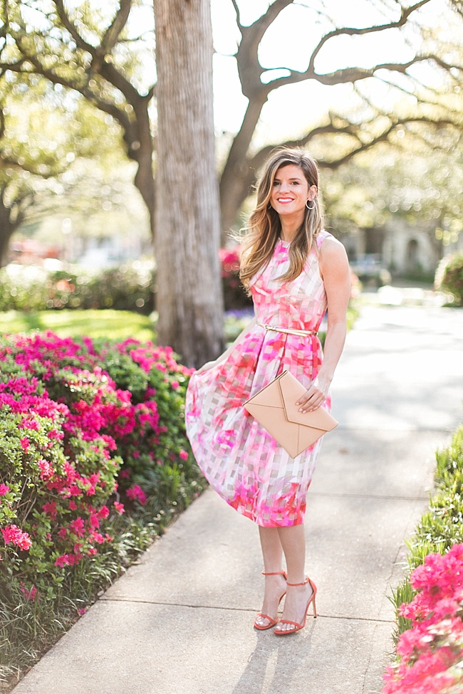 Brighton the day wearing a floral spring dress with nude clutch 