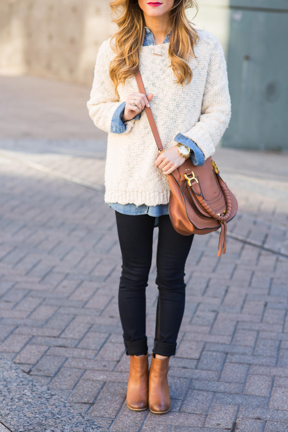 denim shirt + sweater + cognac booties + dark skinny jeans