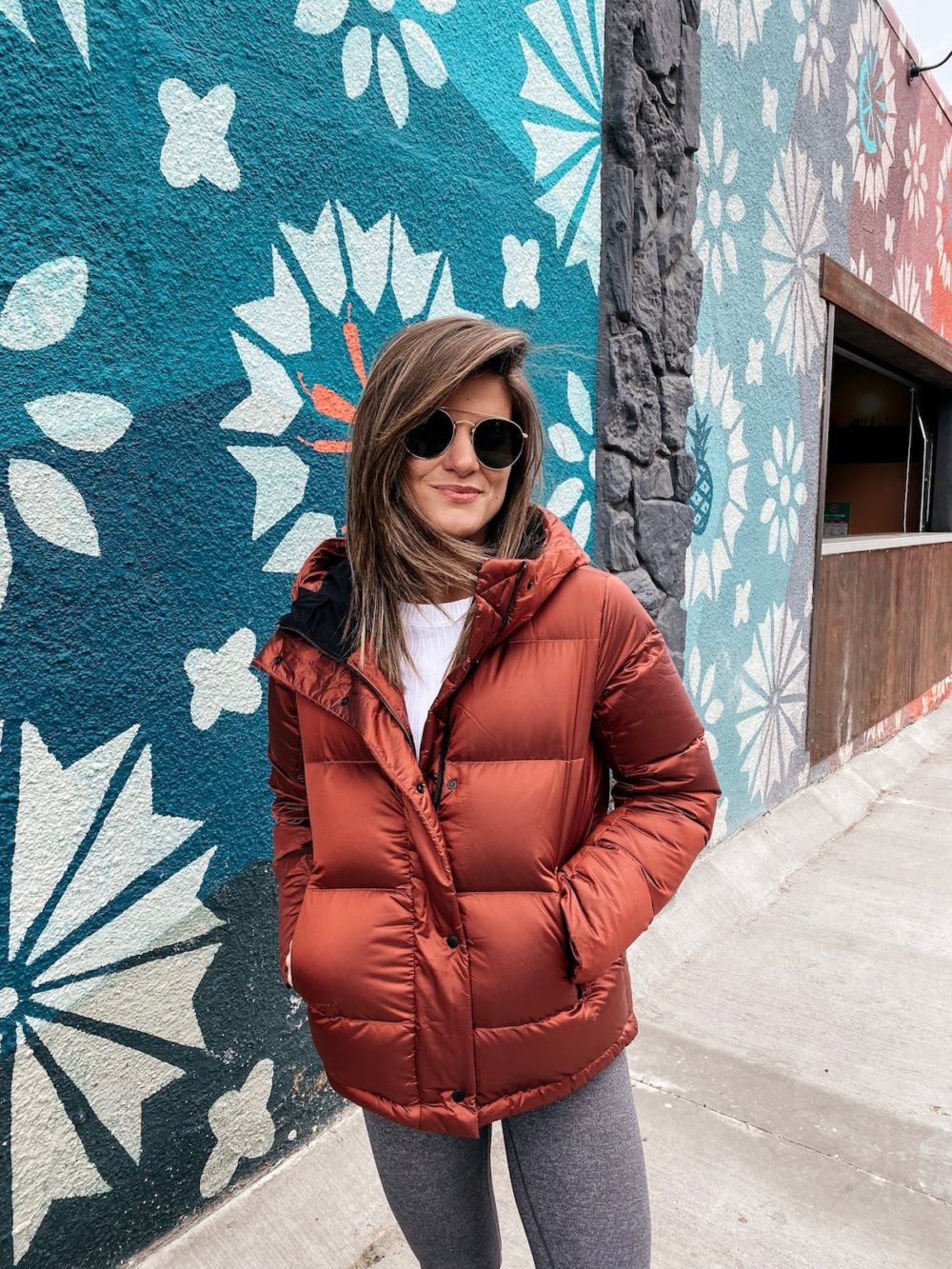 Brighton Keller wearing Lululemon sunset orange puffer and Lululemon white top