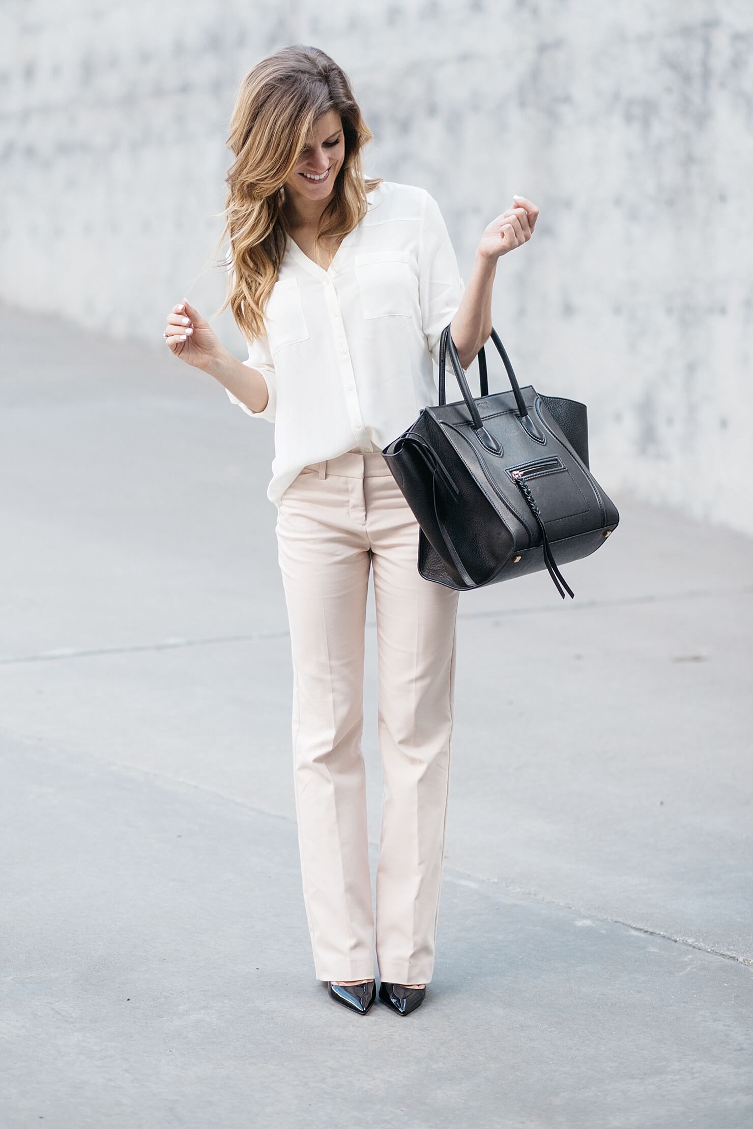 business casual outfit, express editor barely bootcut pants, blush pink pants with off white blouse, express work clothing. business casual outfit idea, prada black patent pumps, black pumps with blush pants, celine phantom bag