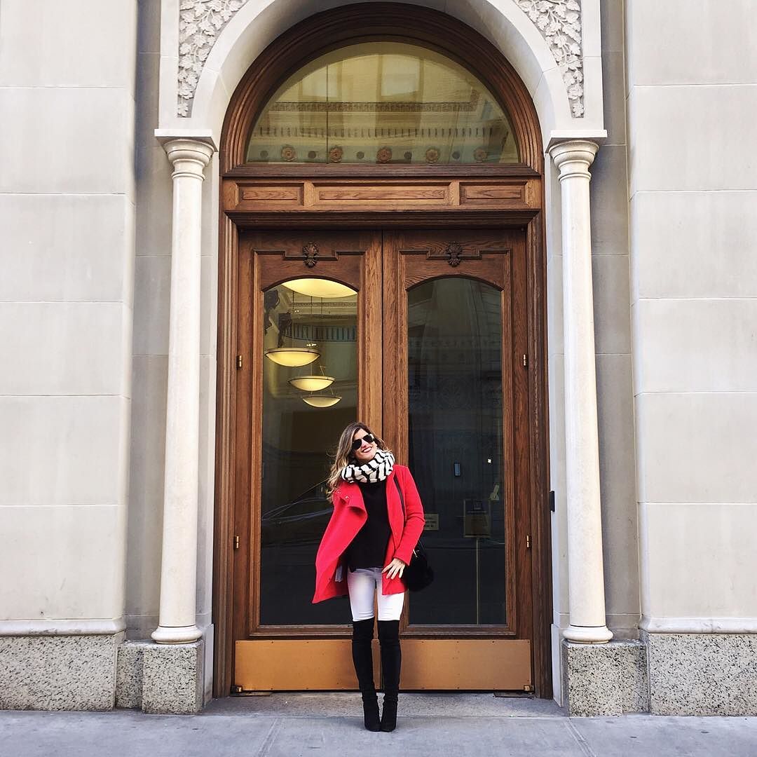 @brightonkeller instagram photo in red coat, white jeans, stuart weitzman highlander boots and striped scarf