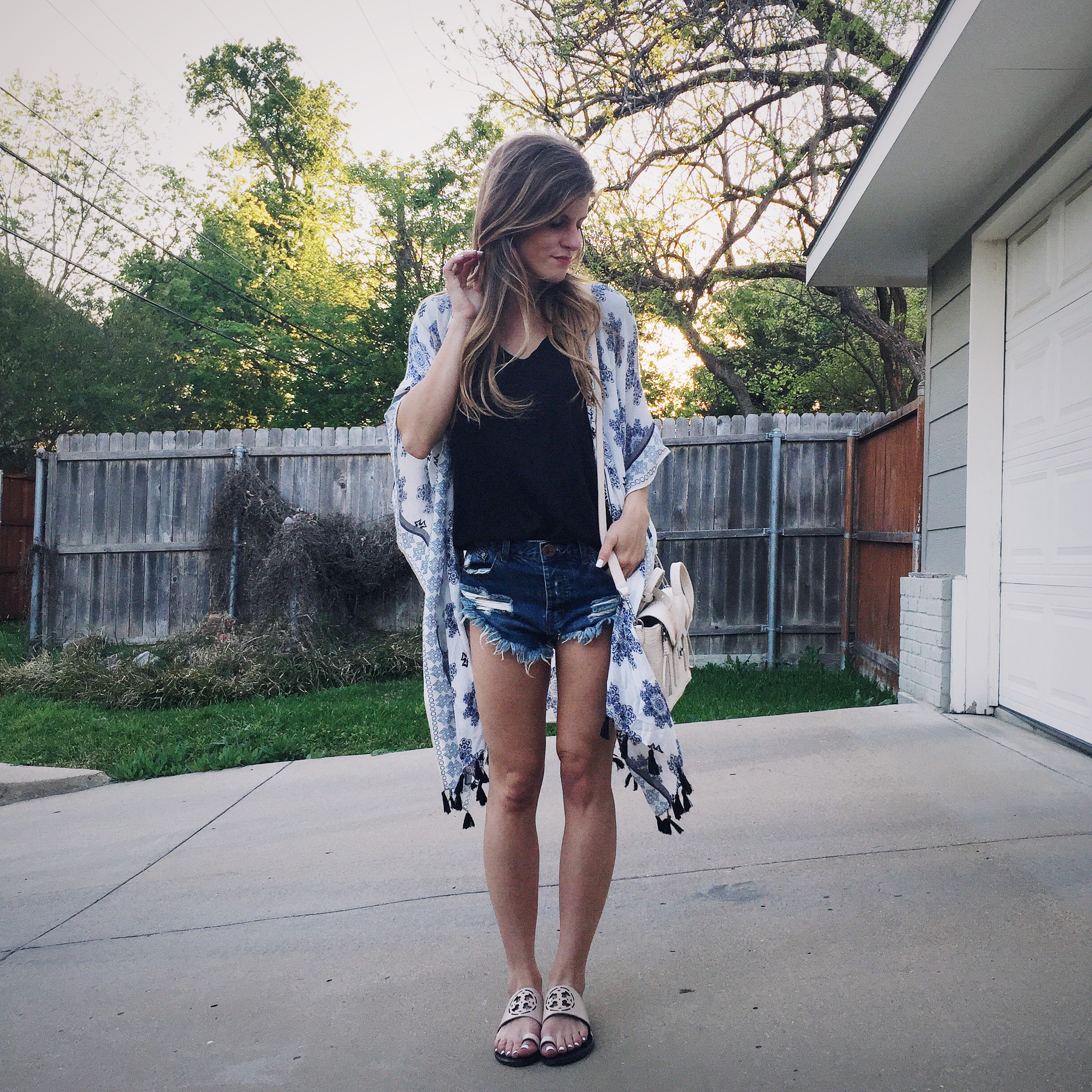 brighton the day wearing printed fringe kimono with jean shorts and tee shirt