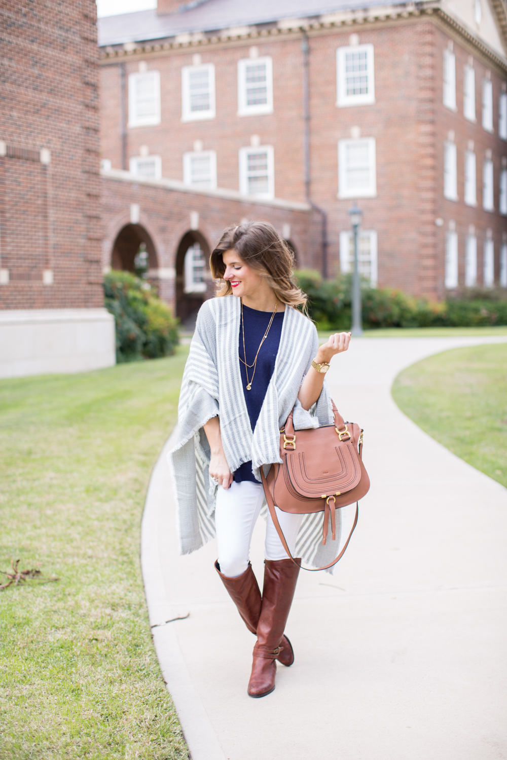 Grey poncho white jeans and brown riding boots