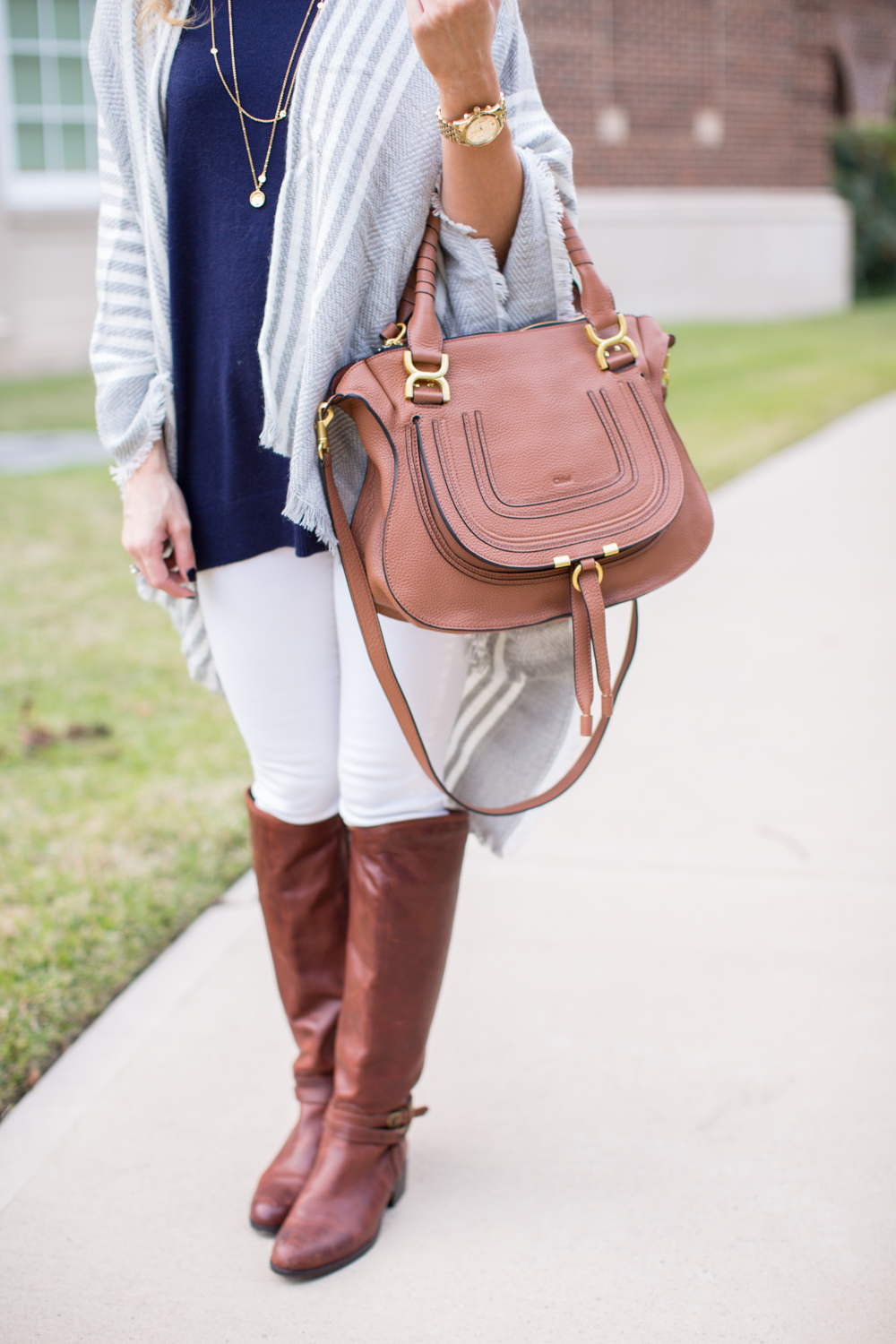 Grey poncho white jeans and brown riding boots