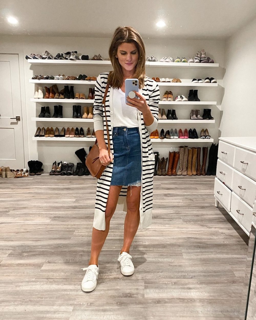 Brighton Keller wearing jean skirt, white tee, duster and sneakers