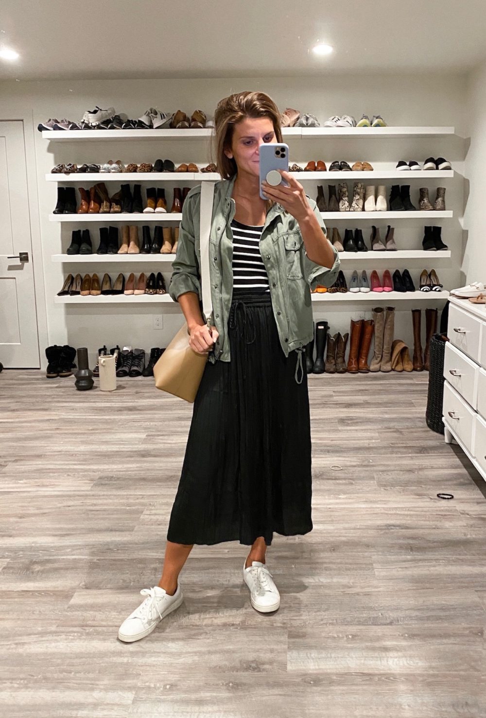 Brighton Keller wearing midi skirt, striped top and military jacket