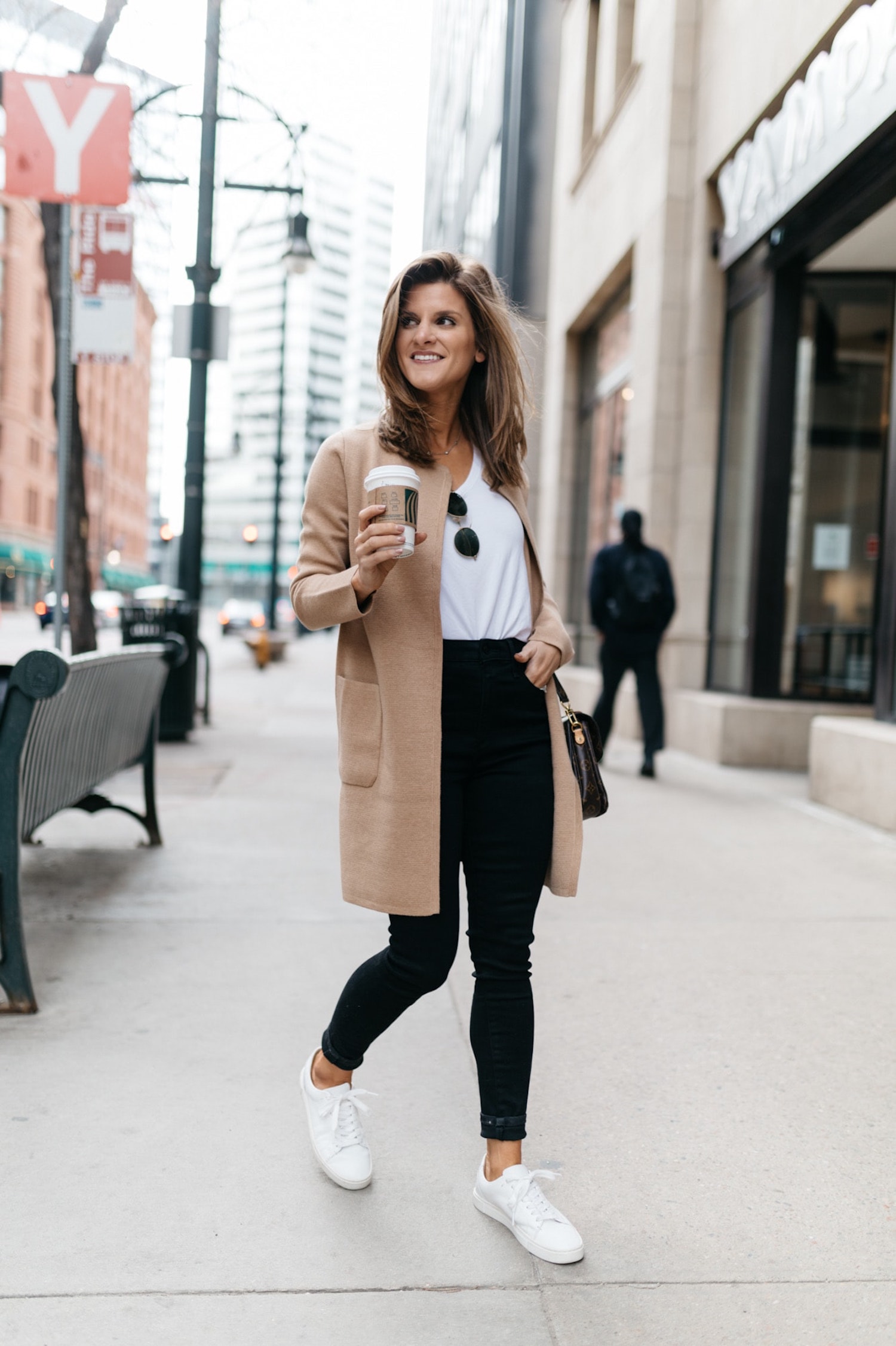 Brighton Butler wearing a crew coatigan, white tee, black jeans and white sneakers