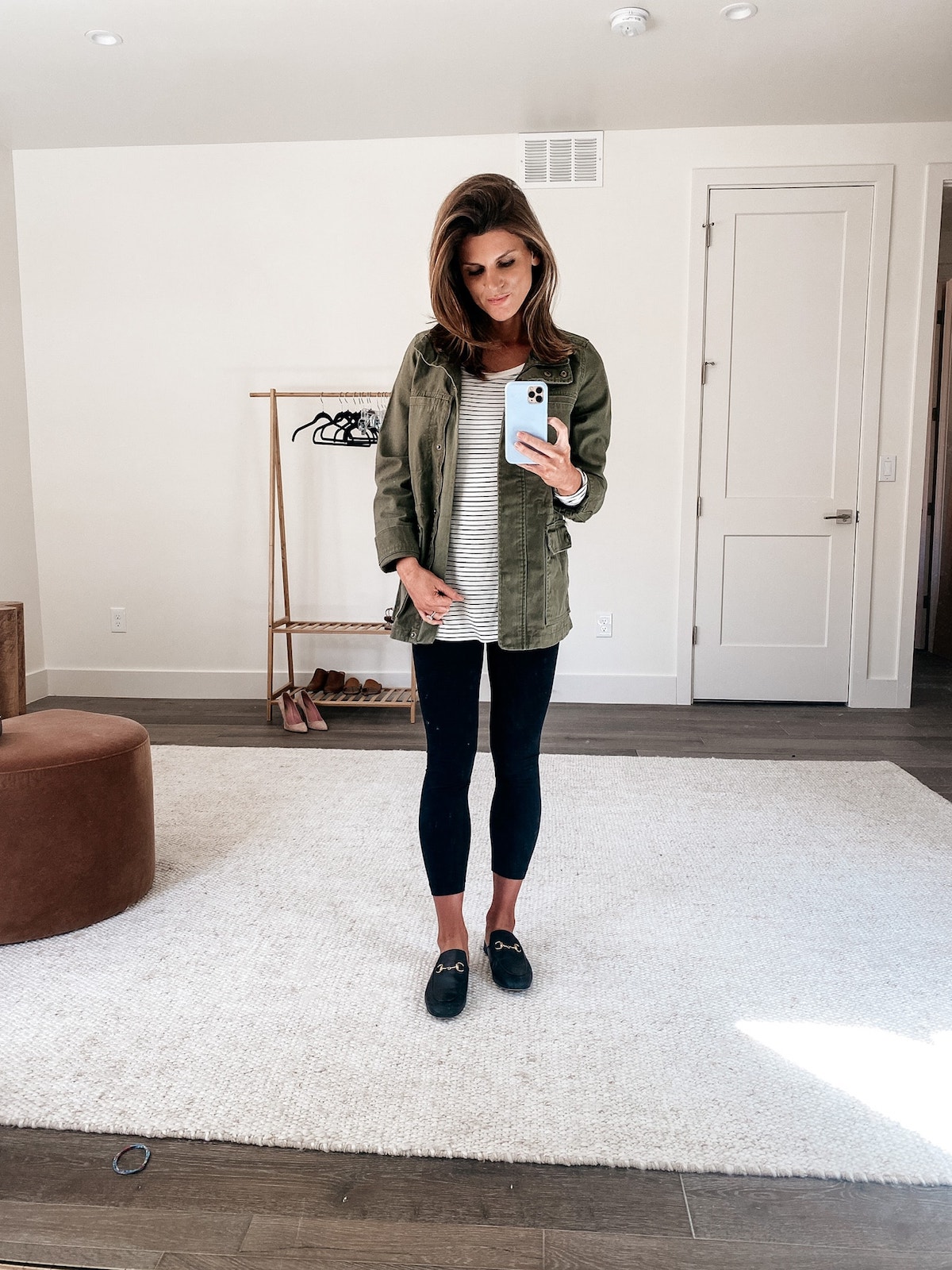 Brighton Keller wearing green military jacket, stripe t-shirt and black leggings