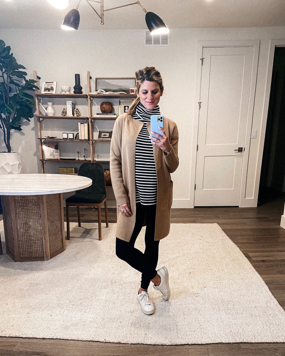 Thanksgiving outfit ideas, Brighton Butler wearing crew coatigan, striped turtleneck, black leggings and white sneakers