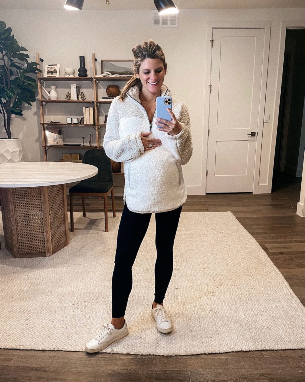 Brighton Butler wearing half-zip sherpa pullover, leggings and sneakers, pregnancy style