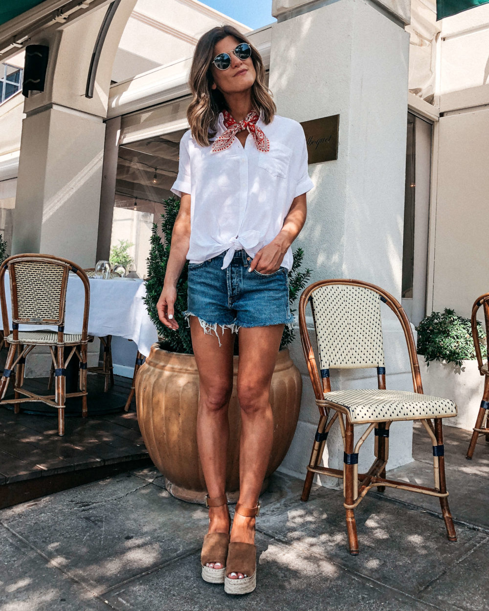 denim shorts, white tie-front top, red banadana, cognac wedges