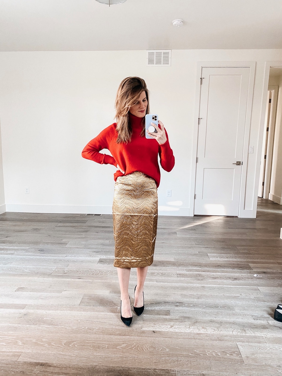 Brighton Keller wearing red sweater and JCrew gold skirt