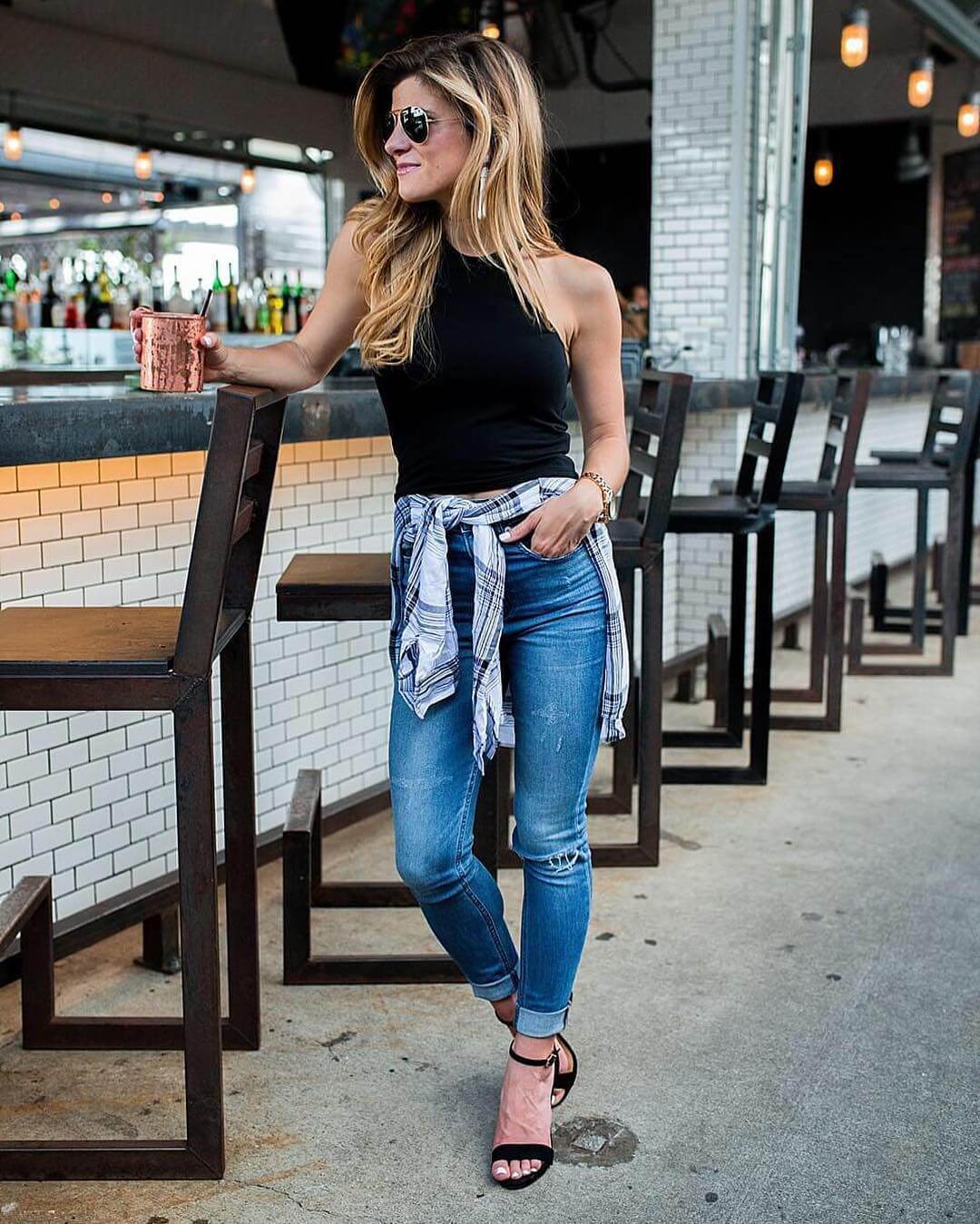 high-waisted denim, cutout black tank and plaid shirt tied around waist summer outfit