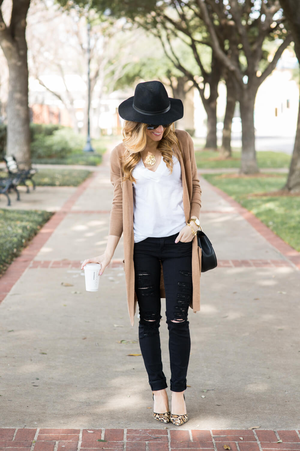 long camel cardigan, black distressed jeans, white t-shirt, black floppy hat, leopard heels, how to wear leopard outfit, dressed up white t-shirt outfit, trendy fall outfit, black chloe bag, starbucks fall outfit