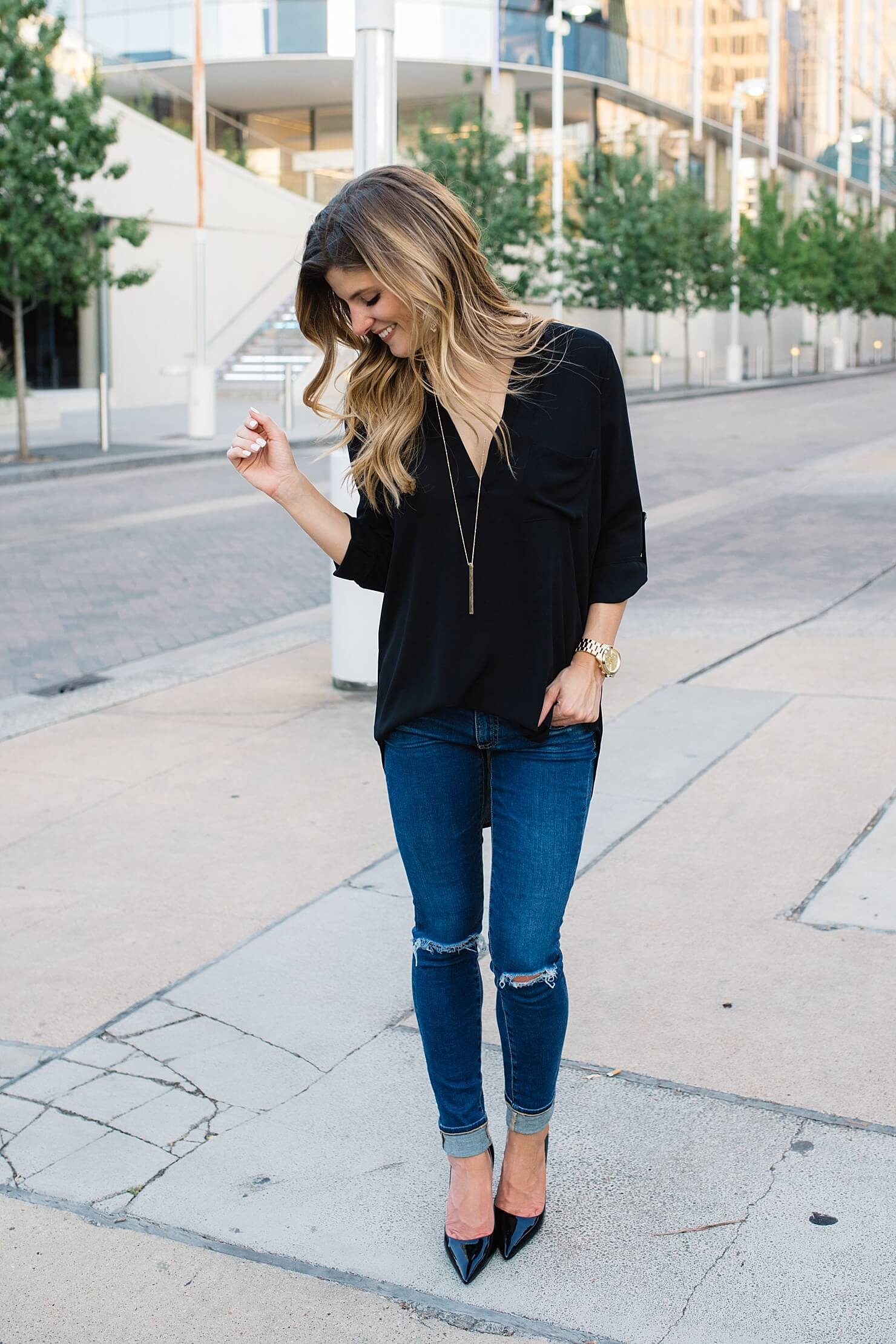 distressed denim + black top + gold necklace + pointy toe black pumps 