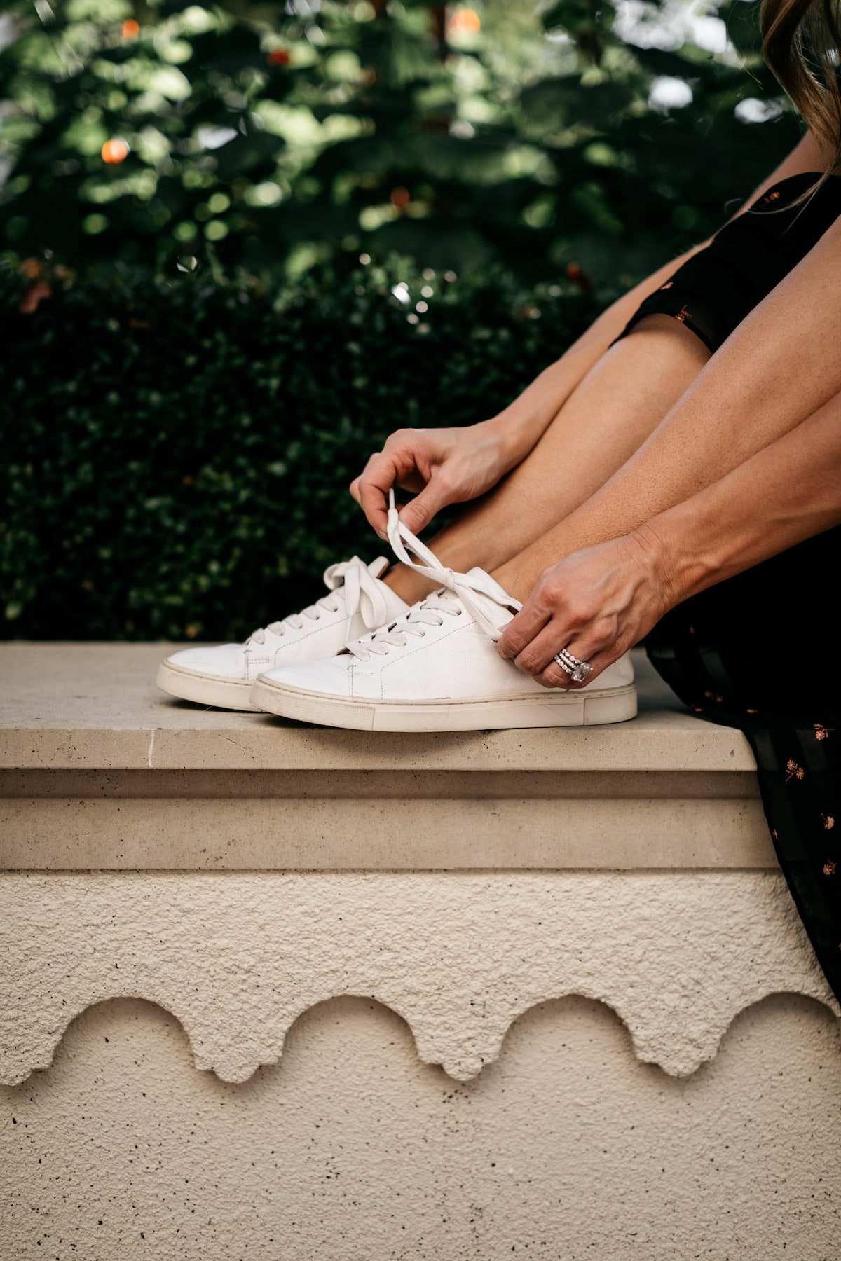 Brighton Butler wearing Madewell Fall Floral Skirt with Black tee and Frye white sneakers