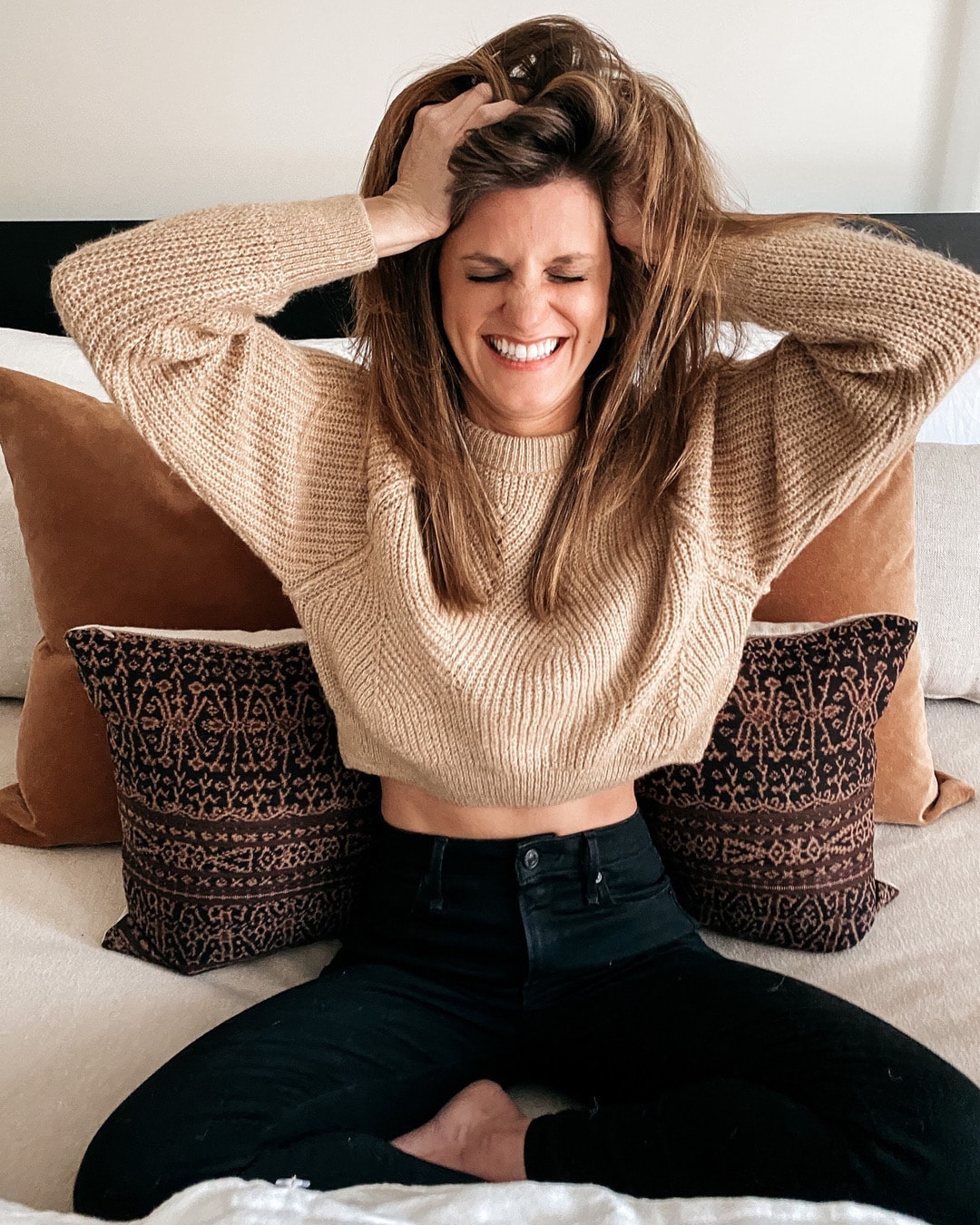 Brighton Keller wearing tan crop sweater and black jeans